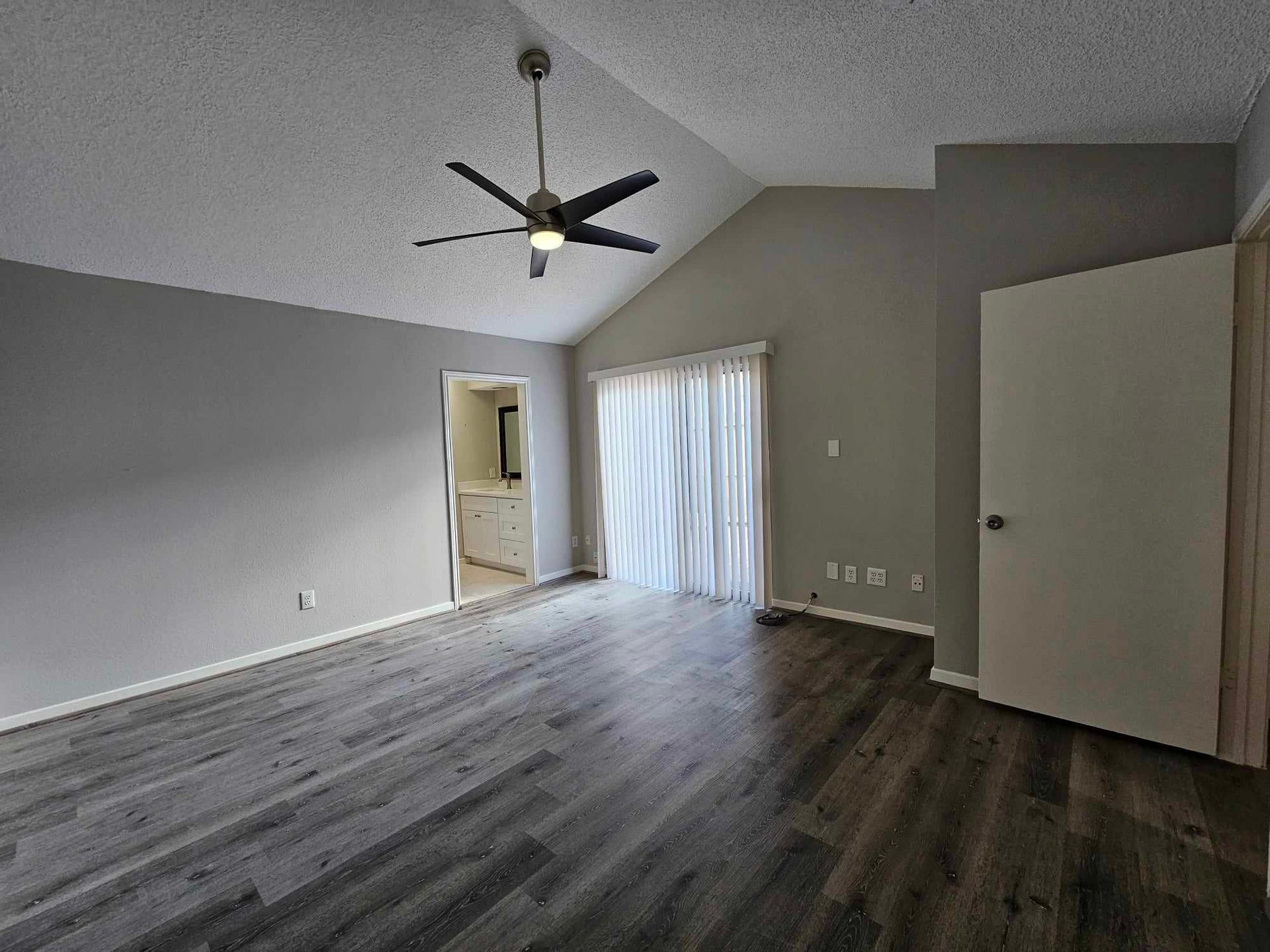 Primary bedroom with double door to backyard