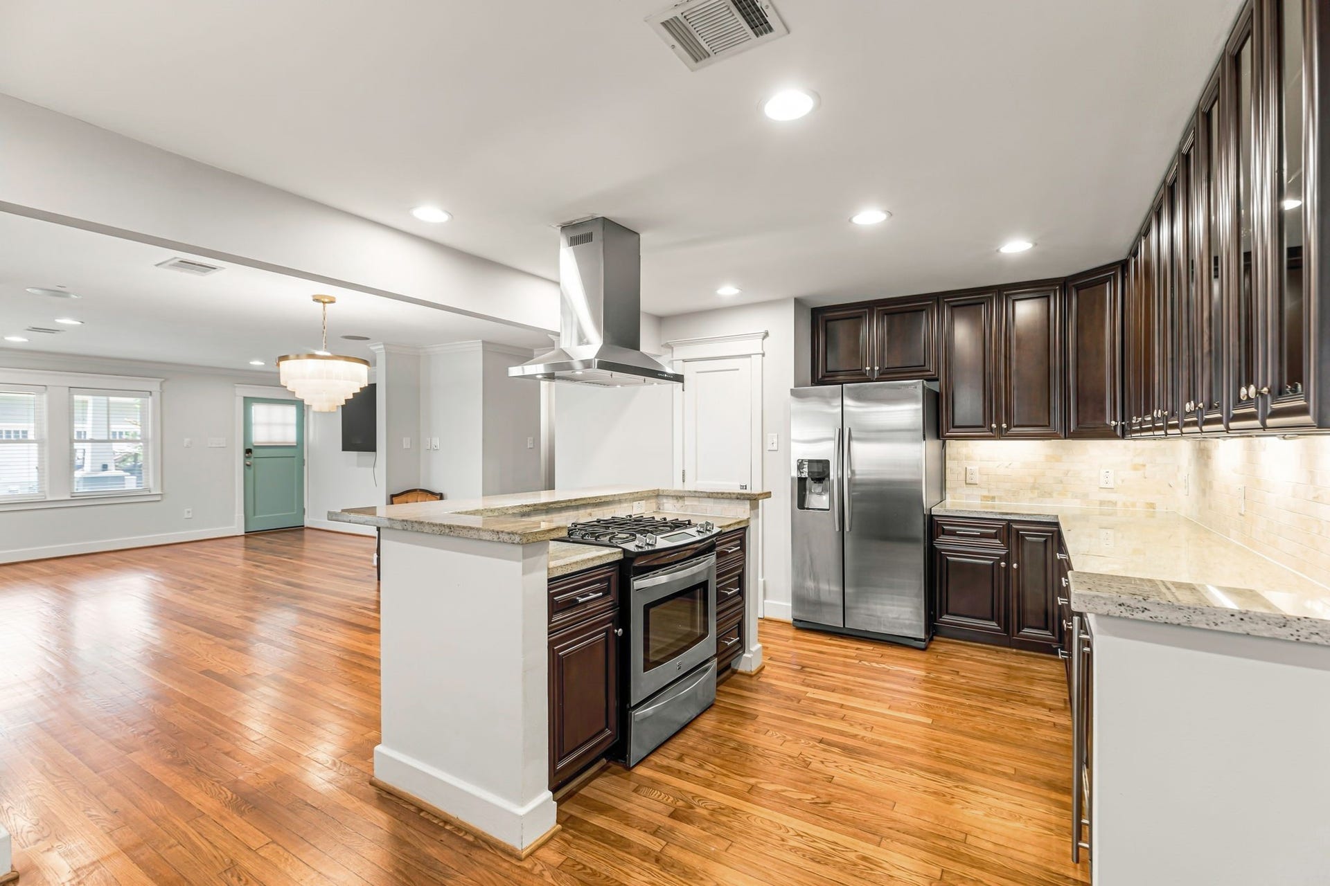 1329 Lawrence Street, Houston, TX 77008 Kitchen with gas cooking, new range hood, under cabinet lighting with plenty of storage.