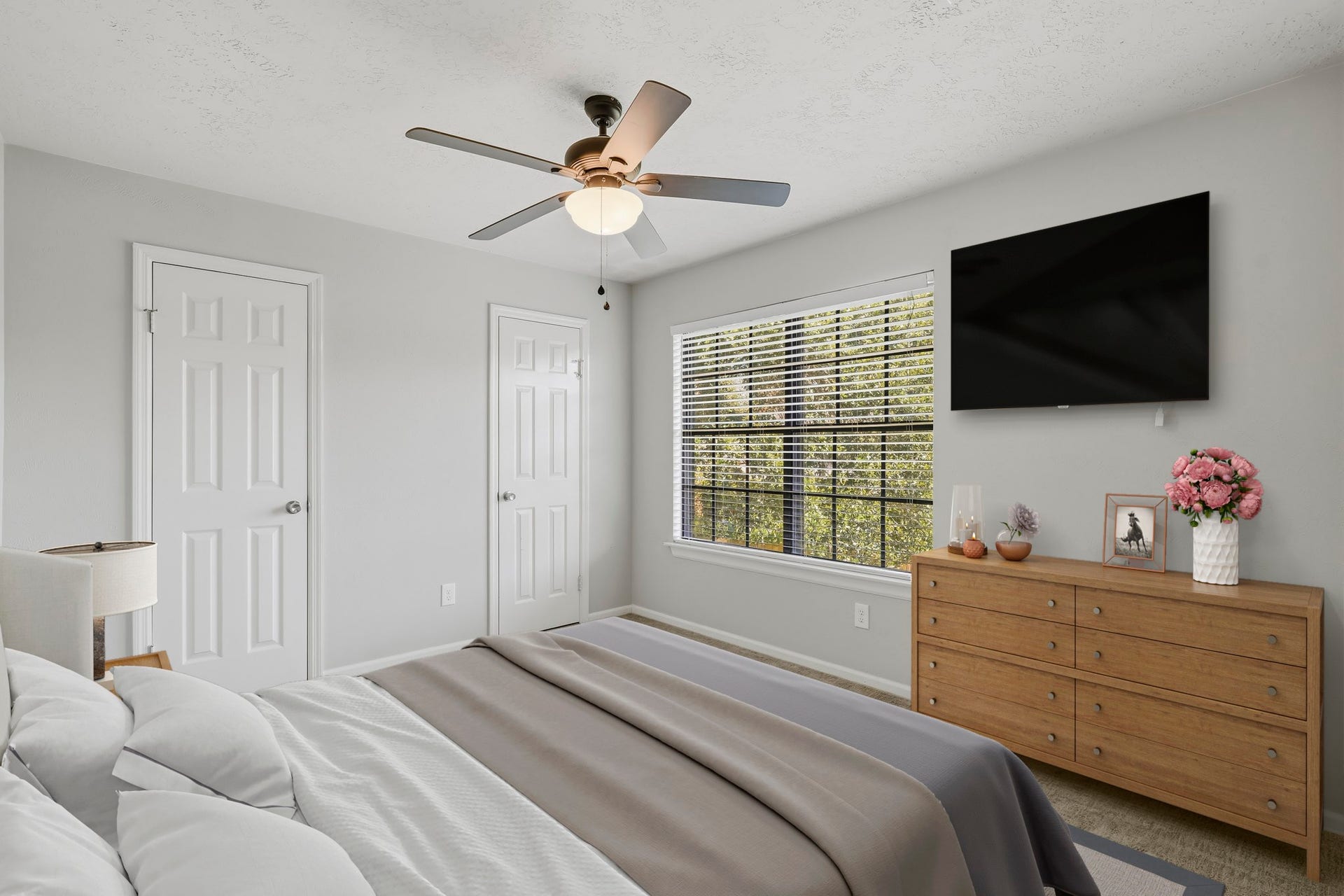 3311 Richmond Ferry Court, Richmond, TX 77406 Virtually Staged: This inviting secondary bedroom features neutral gray walls, soft carpeting, and a large window that brings in plenty of natural light. A ceiling fan adds everyday comfort, while the spacious layout, closet storage, and versatile floor plan provide plenty of room for a complete bedroom setup.