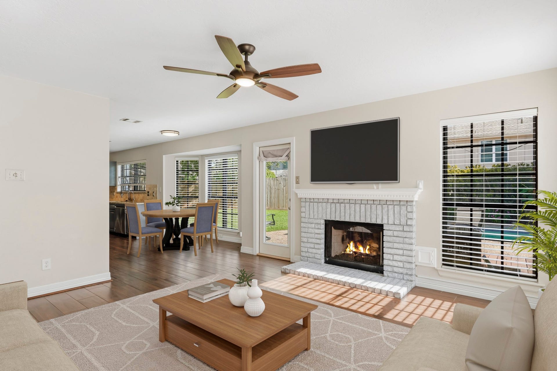3311 Richmond Ferry Court, Richmond, TX 77406 Virtually Staged: The open layout flows seamlessly toward the adjoining kitchen and breakfast area, while a glass-paneled door provides convenient backyard access.