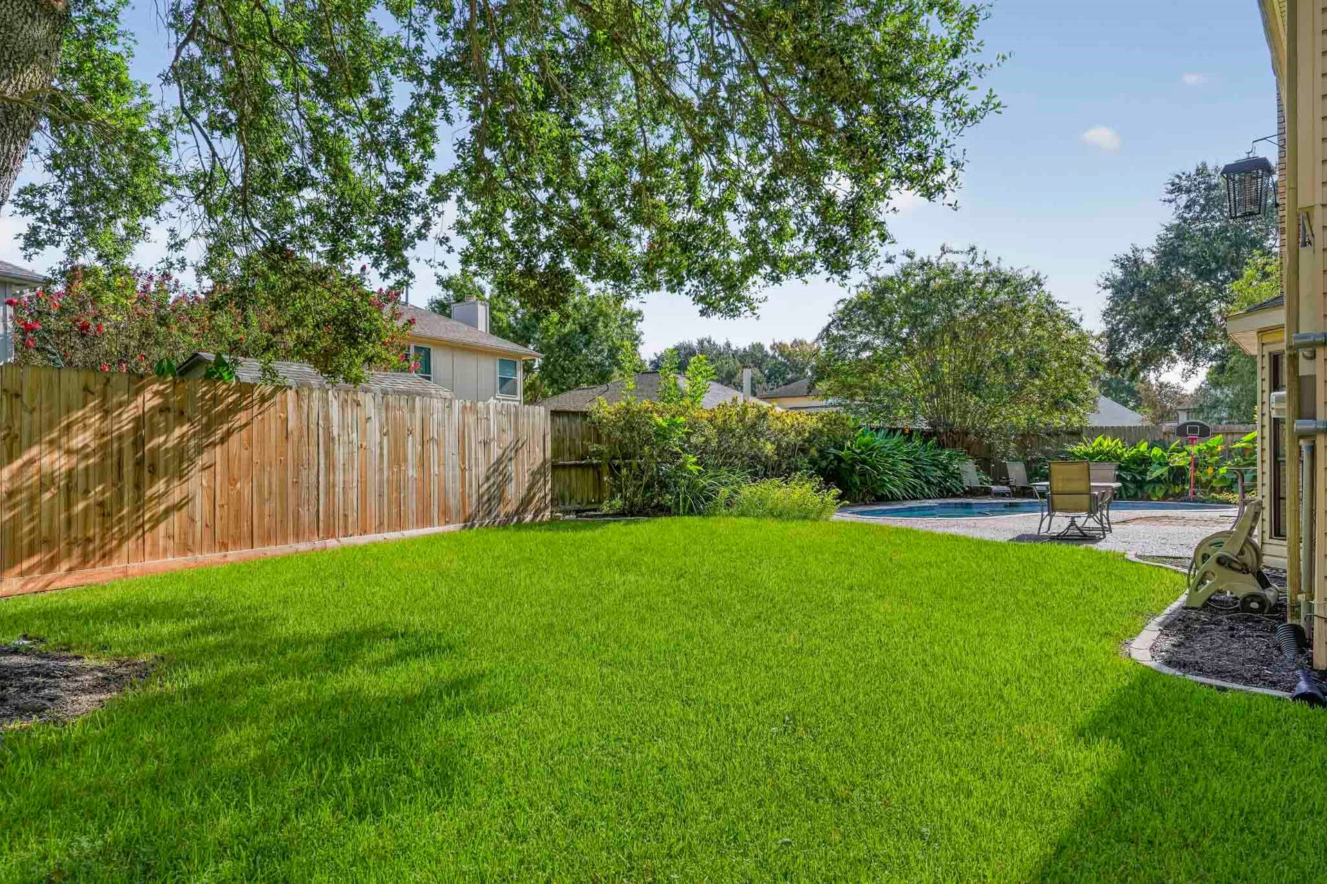 3311 Richmond Ferry Court, Richmond, TX 77406 The fenced backyard is framed by mature trees and lush landscaping.