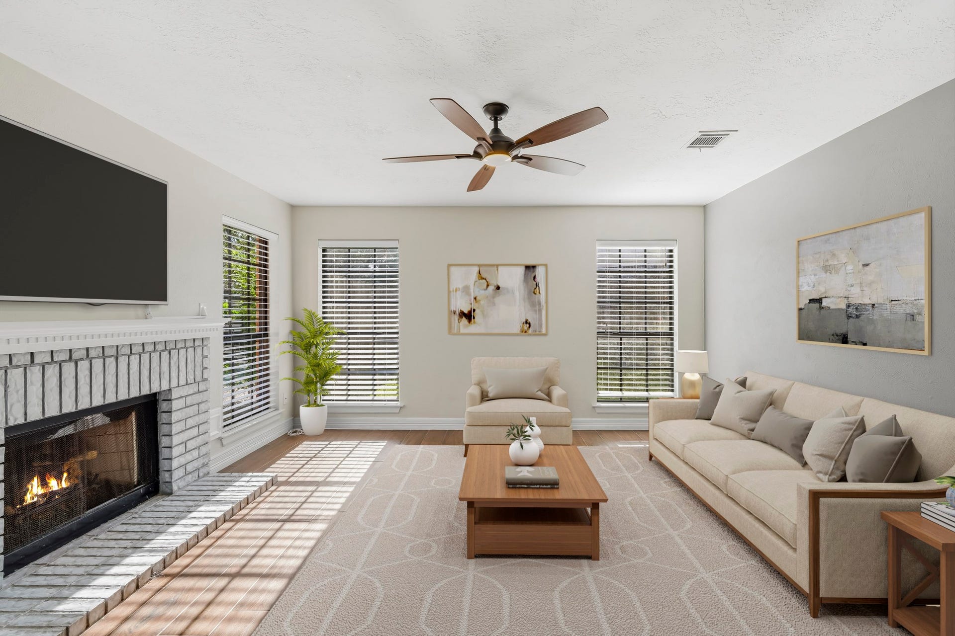 3311 Richmond Ferry Court, Richmond, TX 77406 Virtually Staged: This spacious living area features warm wood-look flooring, a classic brick fireplace, and multiple large windows that fill the room with natural light. A ceiling fan adds everyday comfort, while the open layout provides plenty of flexibility for a generous seating arrangement and entertainment area.