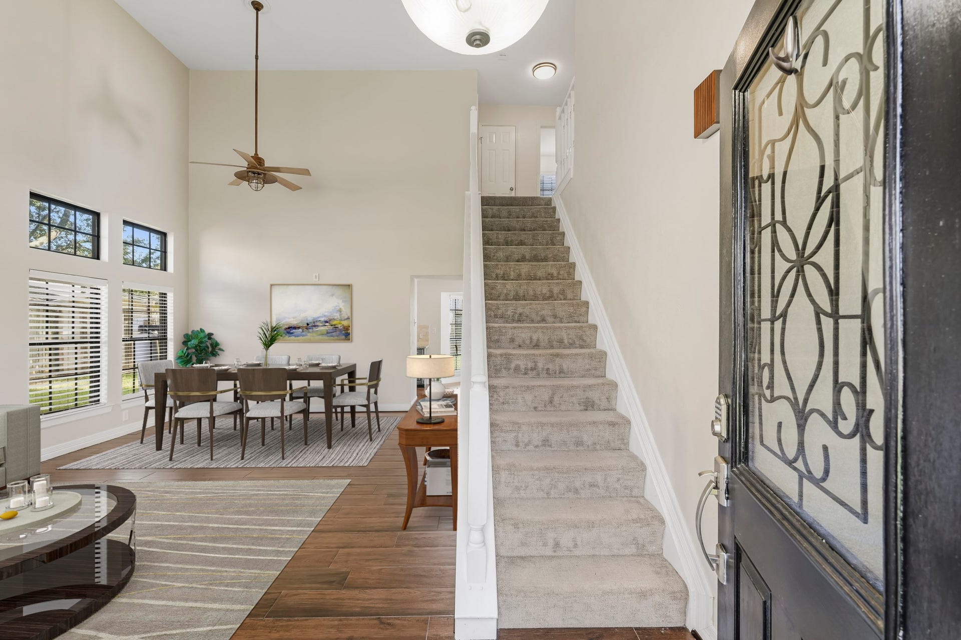 3311 Richmond Ferry Court, Richmond, TX 77406 Virtually Staged: This bright, open entryway welcomes you into the home with soaring ceilings, warm wood-look flooring, and abundant natural light from multiple windows.