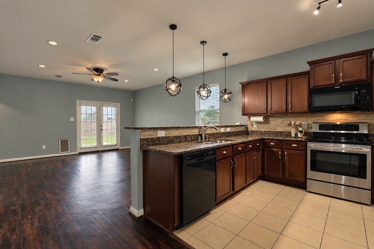 1634 Pink Stone Drive, Rosharon, TX 77583 One of the nice features of this home is the gorgeous flooring, no carpet in the living areas and french doors welcome you to the covered patio.