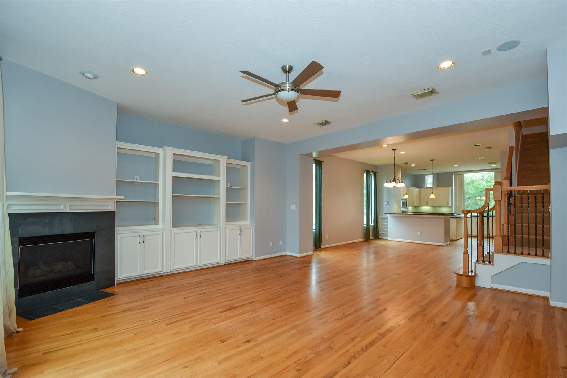 514 Birdsall Street, Houston, TX 77007 Open family room with fireplace and cabinets/built-ins, recessed lights