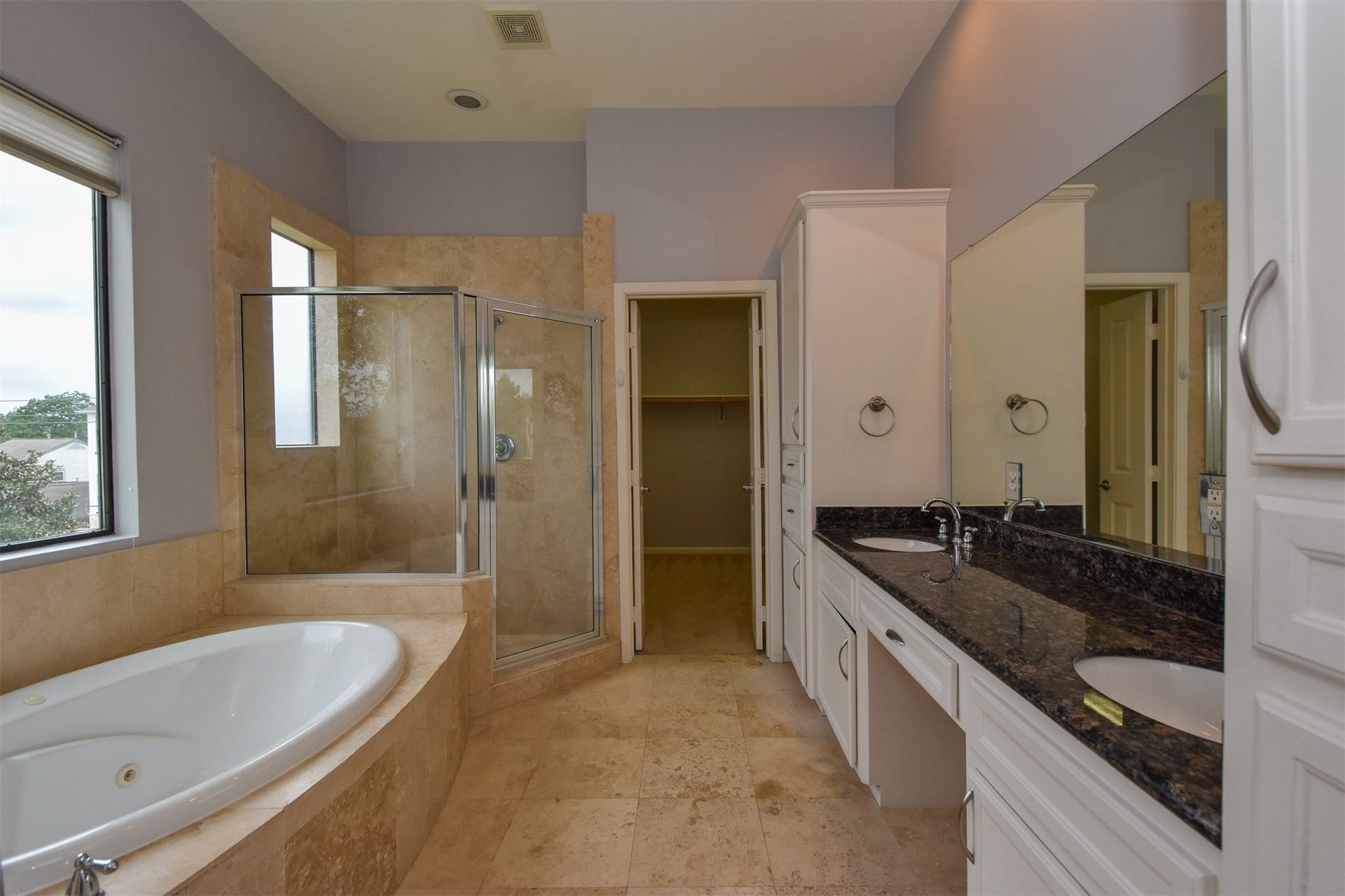 514 Birdsall Street, Houston, TX 77007 Master bathroom with double vanities, travertine floors, jacuzzi tub and walk-in shower