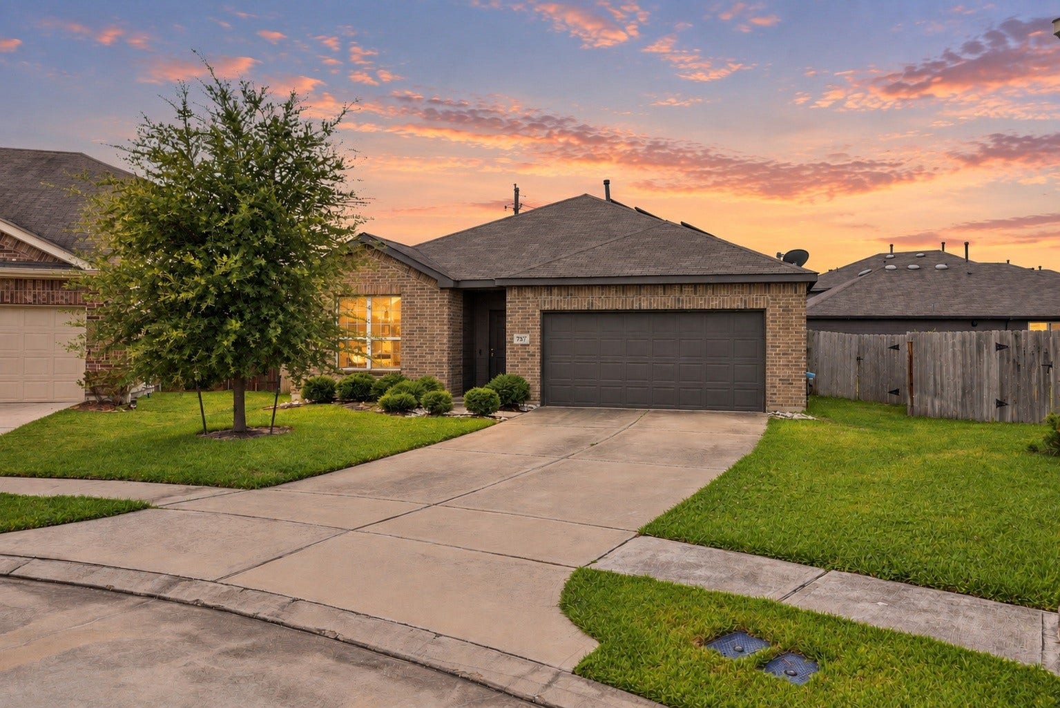 2307 Northern Great White Court, Katy, TX 77449 Designed with traditional charm, this single-family home highlights structured brick masonry and an oversized garage layout. The front yard offers a expansive lawn, mature greenery, and a covered entry recess for a clean, cohesive facade.