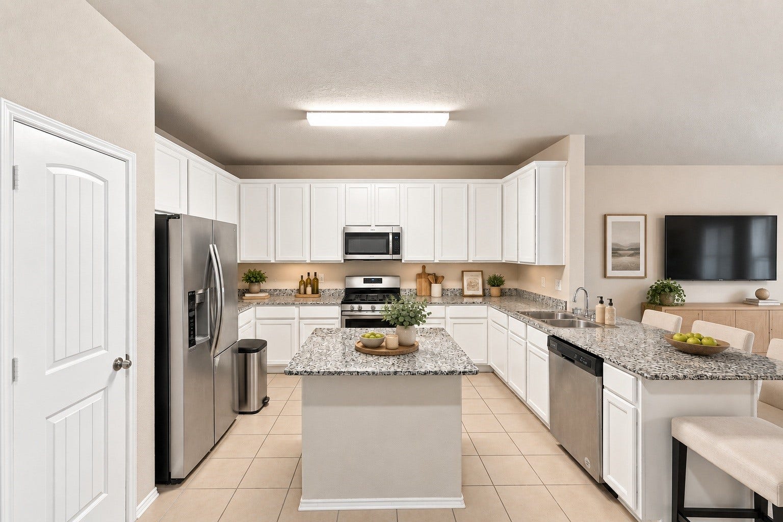 2307 Northern Great White Court, Katy, TX 77449 This direct perspective reveals the kitchen's symmetrical cabinetry arrangement and generous counter area. Featuring a built-in microwave, gas range, double sink, and dishwasher.