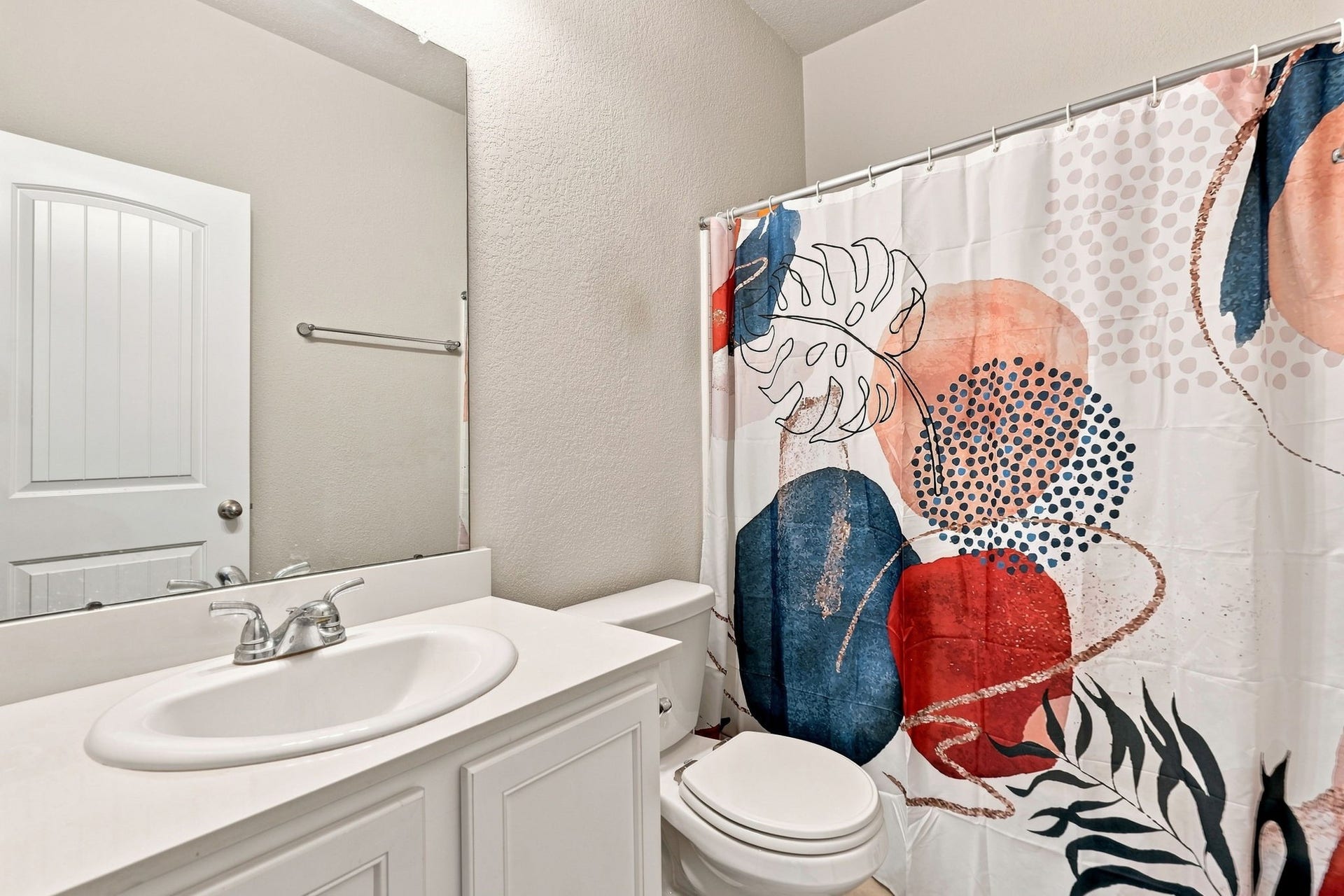 2307 Northern Great White Court, Katy, TX 77449 A clean and efficient full bath offering a integrated shower-tub setup paired with crisp tile surrounds. The functional layout includes a spacious single vanity, broad mirror, and durable flooring designed for daily use.