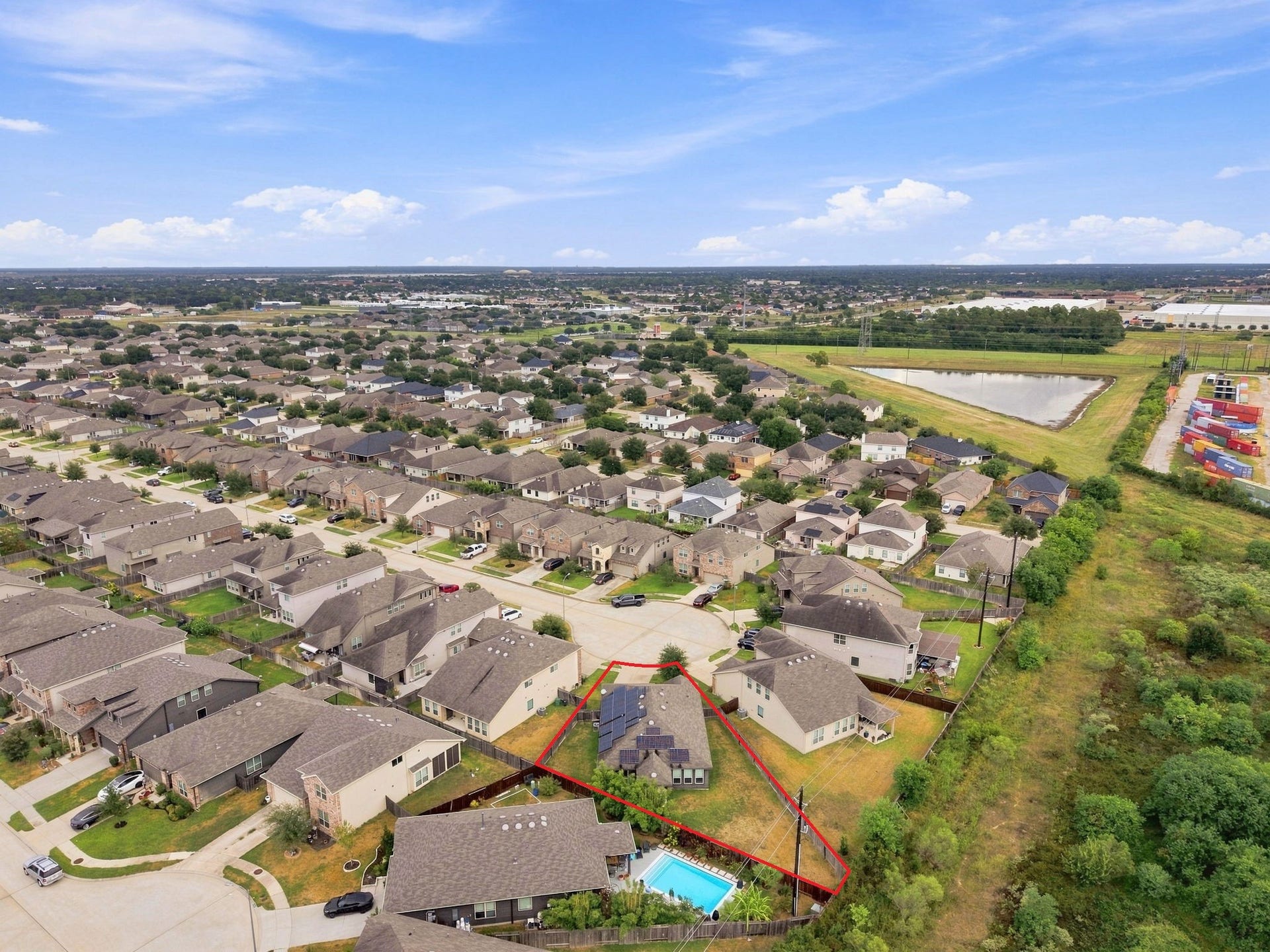 2307 Northern Great White Court, Katy, TX 77449 Bordered by open green land and a nearby retention pond, the property combines suburban living with a secluded, scenic backdrop.