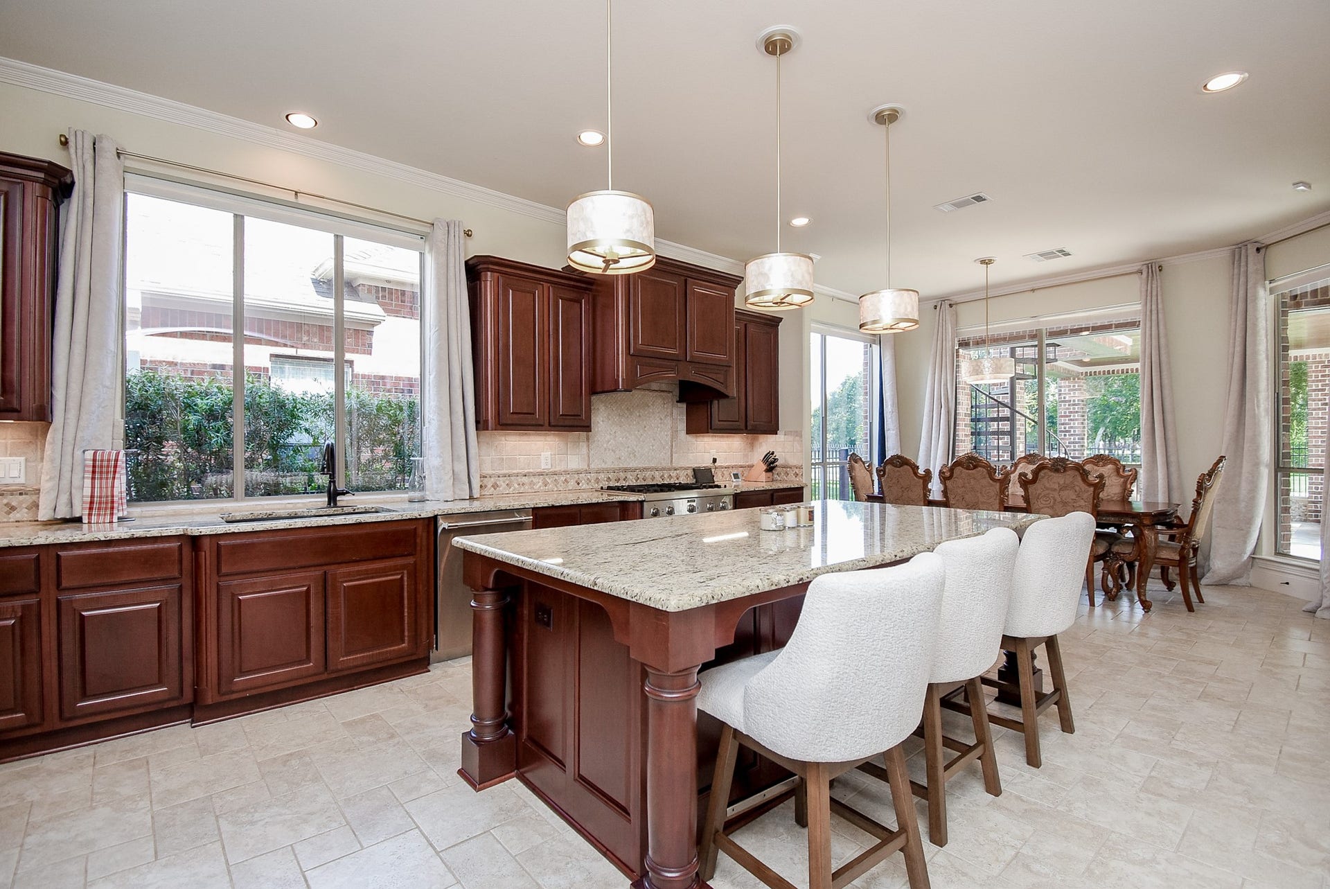 Abundant cabinetry, breakfast bar updated lighting over the island and a large picture window over the sink.
