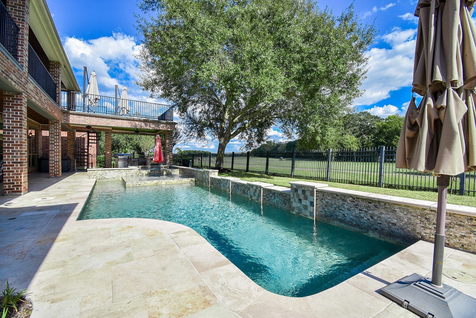 Viewof the beautiful pool area. Travertine tile and pretty accent tiles tie into the natural look of the enviornment.