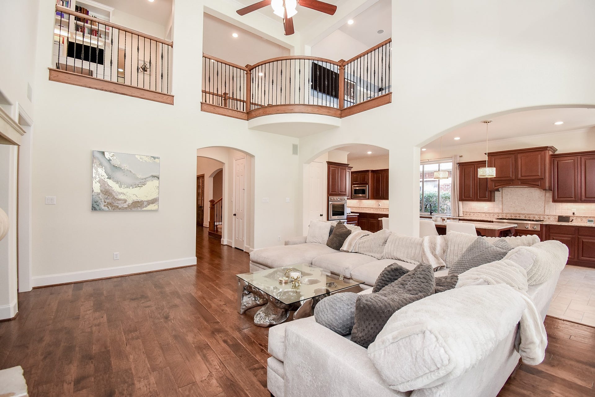 A second view of the family room with Juliet Balcony. The wood flooring continues through the family room..