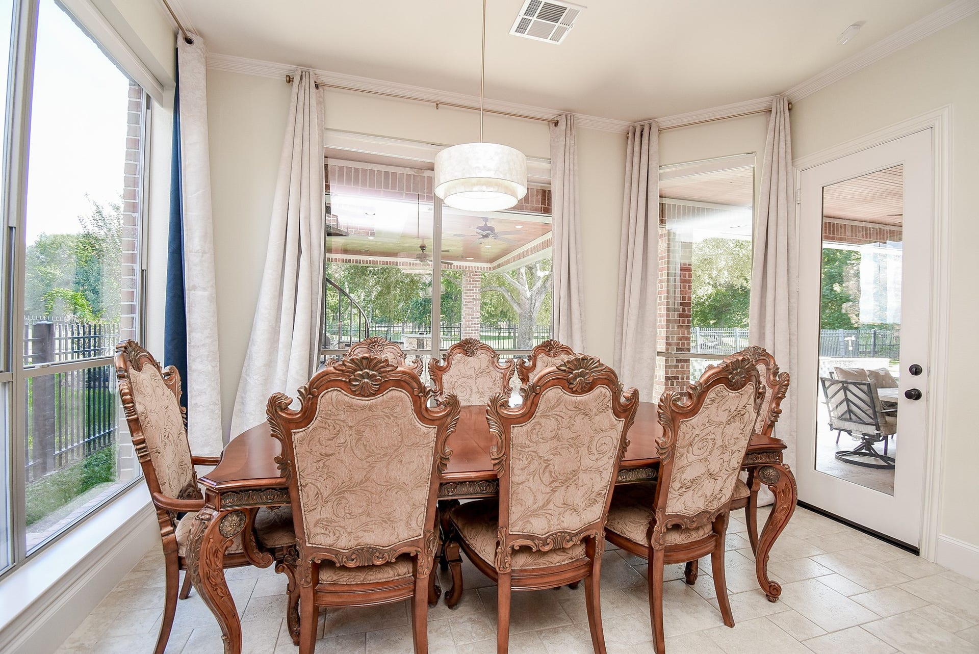 The breakfast room with corner windows allows views to the golf course from multiple locations. Updated light fixture. Tile floors are pretty and easy to care for.