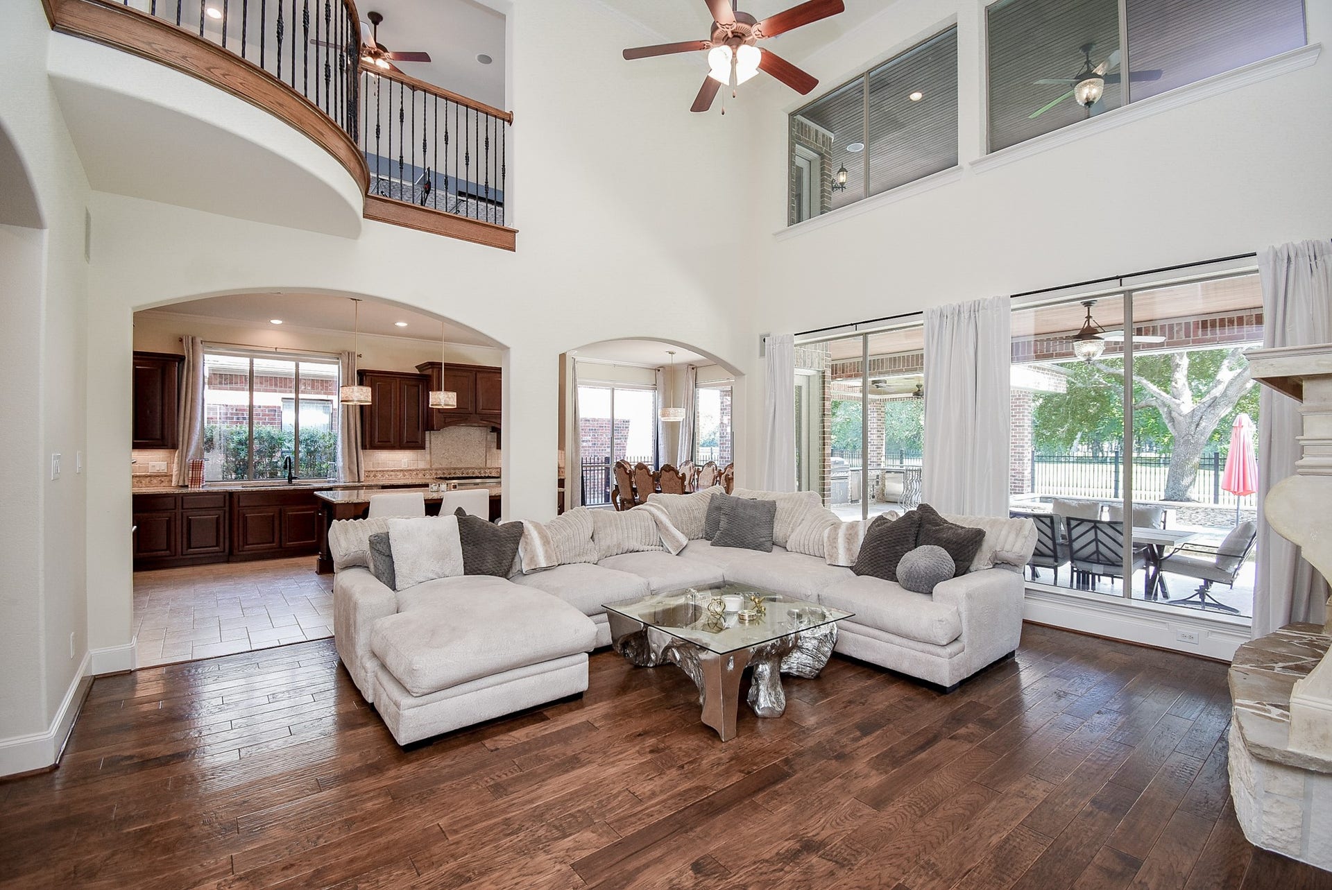 Open concept living. Wall of windows in the family room with views to the Golf Course and pool/spa. The arches accent entry into the kitchen and breakfast area. Neutral paint colors.