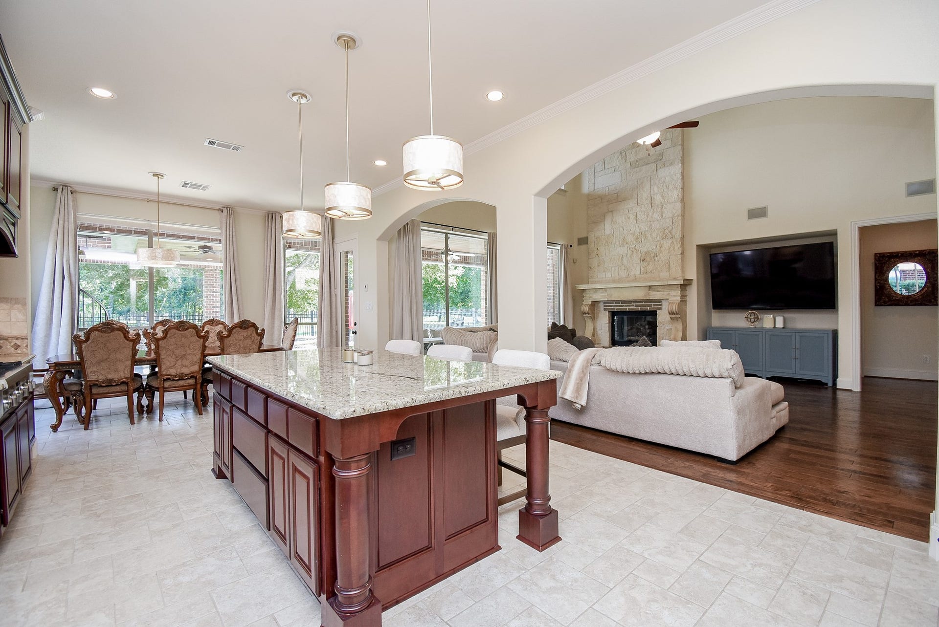 Stone fireplace in the family room with Niche for a large TV. The flow from the kitchen to the family room is continuous. Great entertaining space.