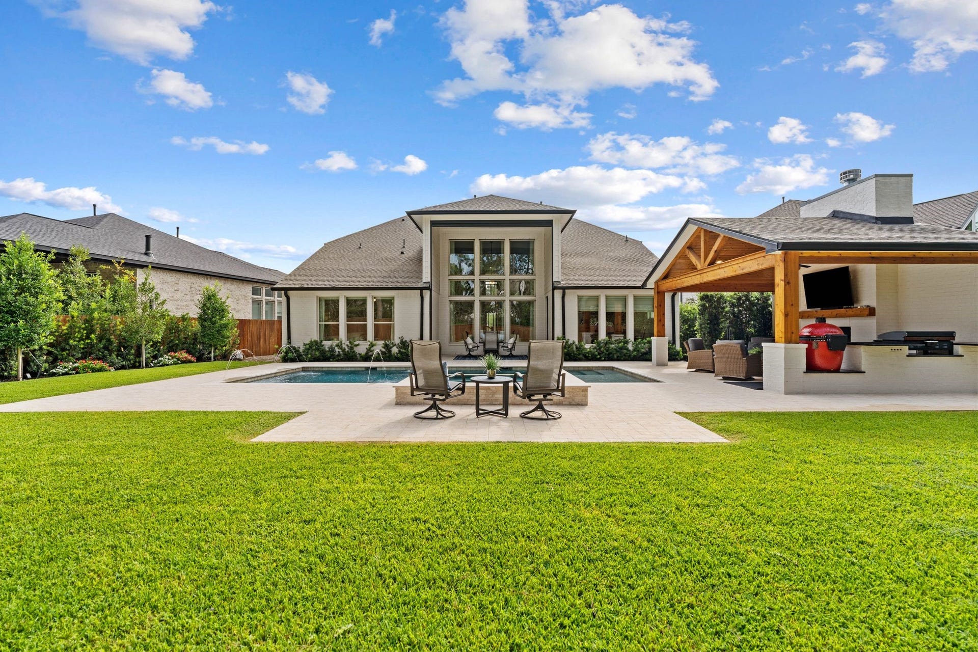 Exceptional private backyard oasis backing to a serene greenbelt, featuring a heated pool and spa, motorized patio screen, cedar-vaulted cabana w/wood-burning fireplace, outdoor kitchen w/Kamado Joe & Blackstone griddle, extensive hardscaping, upgraded fencing, & an unusually large backyard offering incredible privacy & resort-style living!