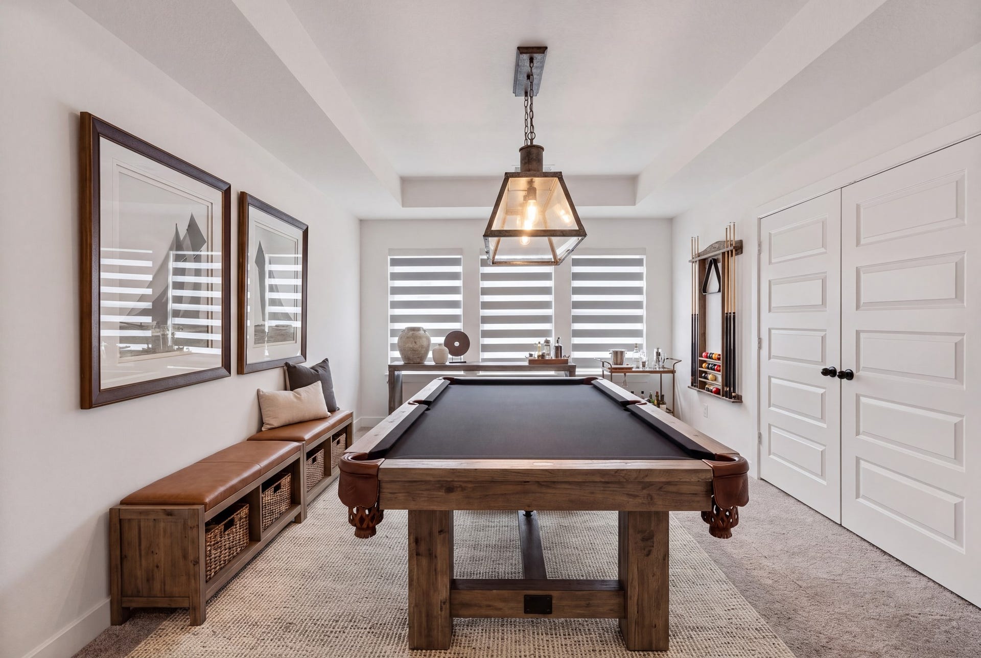 Versatile game room featuring elegant tray ceilings, custom window shades, and ample space for a billiards tableperfect for entertaining, relaxing, and hosting unforgettable nights!