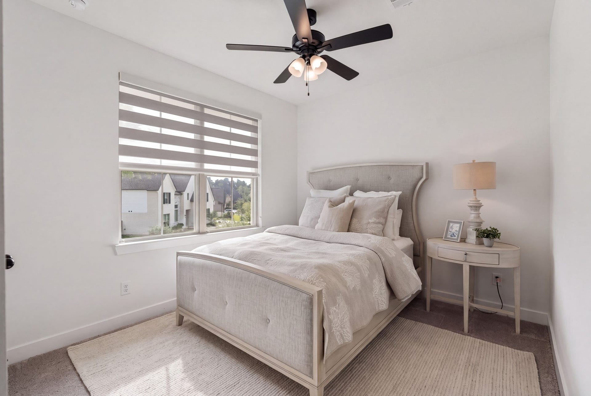 Beautifully appointed upstairs bedroom, one of three on the second level, featuring abundant natural light, & custom window shades. A bright and inviting space offering comfort, privacy, and versatility for family or guests!