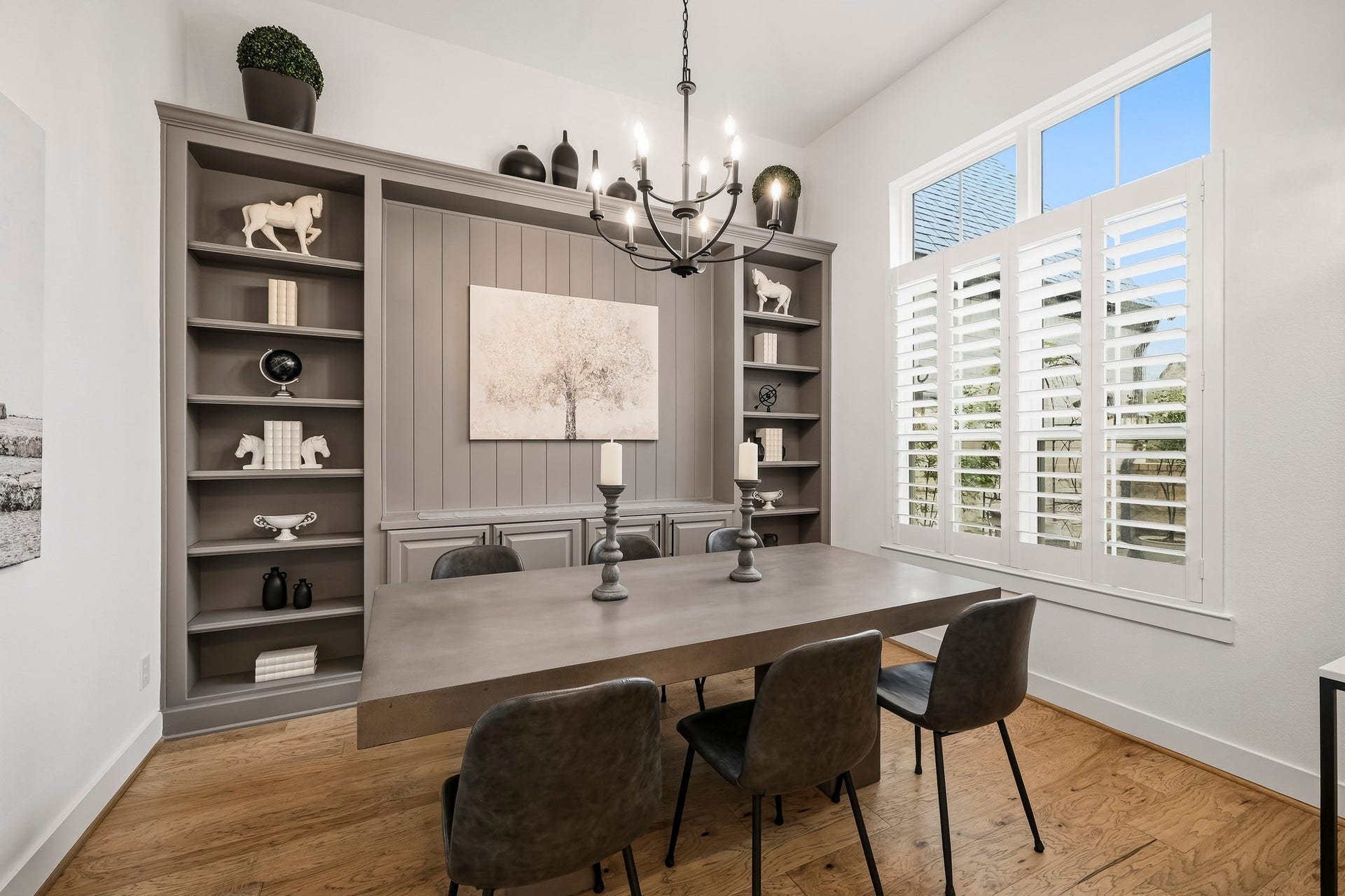 2514 Heritage Park Drive, Missouri City, TX 77459 This gorgeous study currently being used as a dining room has plantation shutters dressing the windows with transoms above, while custom built-in bookshelves and abundant cabinetry elevate the room with a sophisticated blend of architectural detail, storage and everyday functionality.