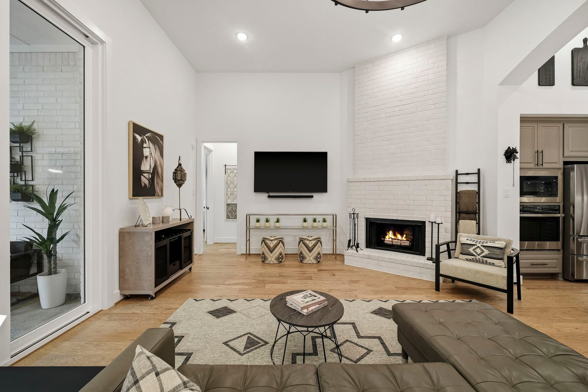 2514 Heritage Park Drive, Missouri City, TX 77459 Anchoring the room is an elegant gas connected fireplace framed by a timeless brick hearth and a dramatic floor-to-ceiling surround, creating a sophisticated architectural focal point with warmth, character and refined appeal.