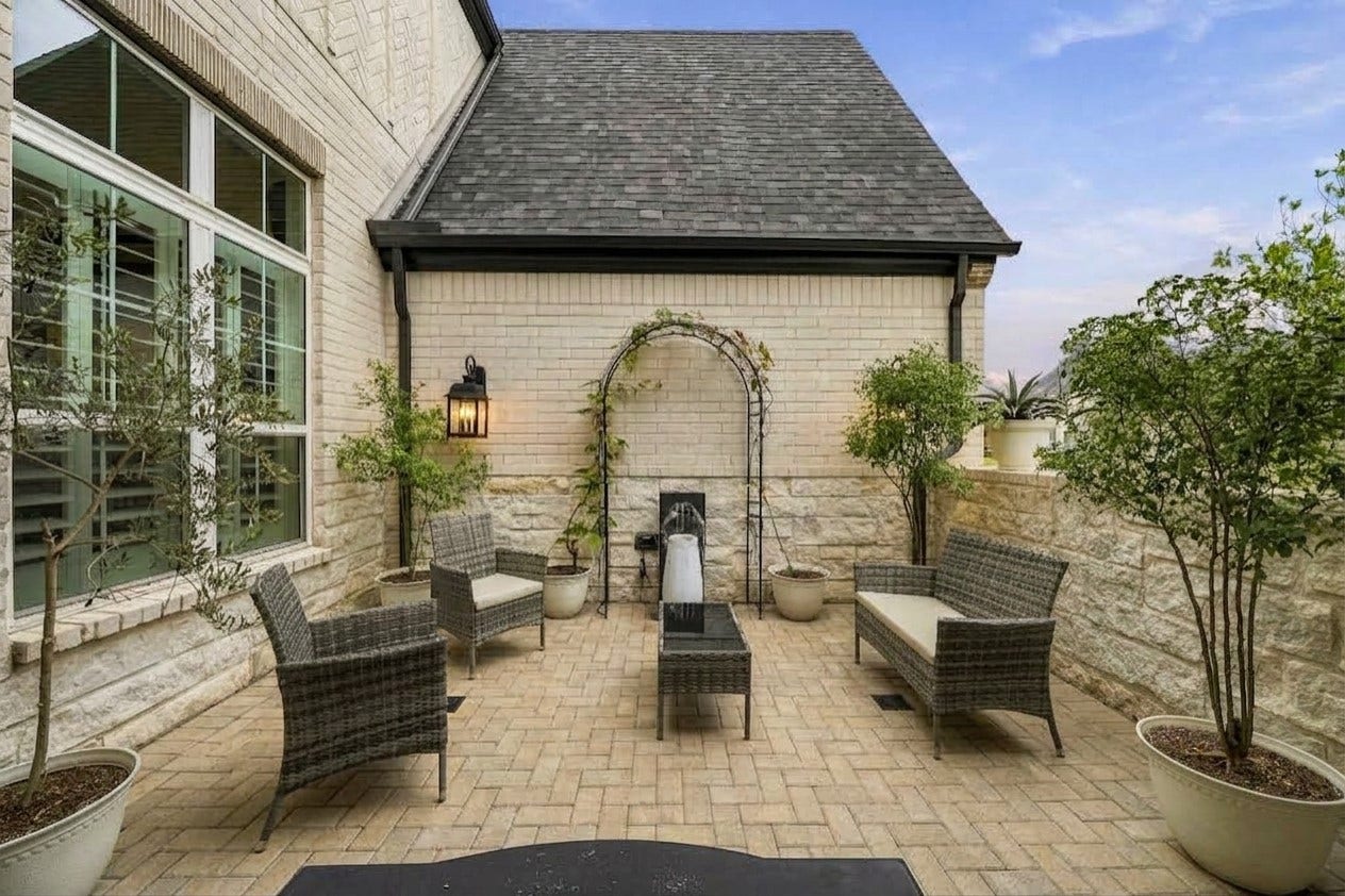 2514 Heritage Park Drive, Missouri City, TX 77459 This grand, 17'x15' gated courtyard with custom gate added in 2022 creates an elegant sense of arrival, with rich brick pavers, natural stone detailing and timeless coach lighting sets a refined, private tone before you even reach the front door.