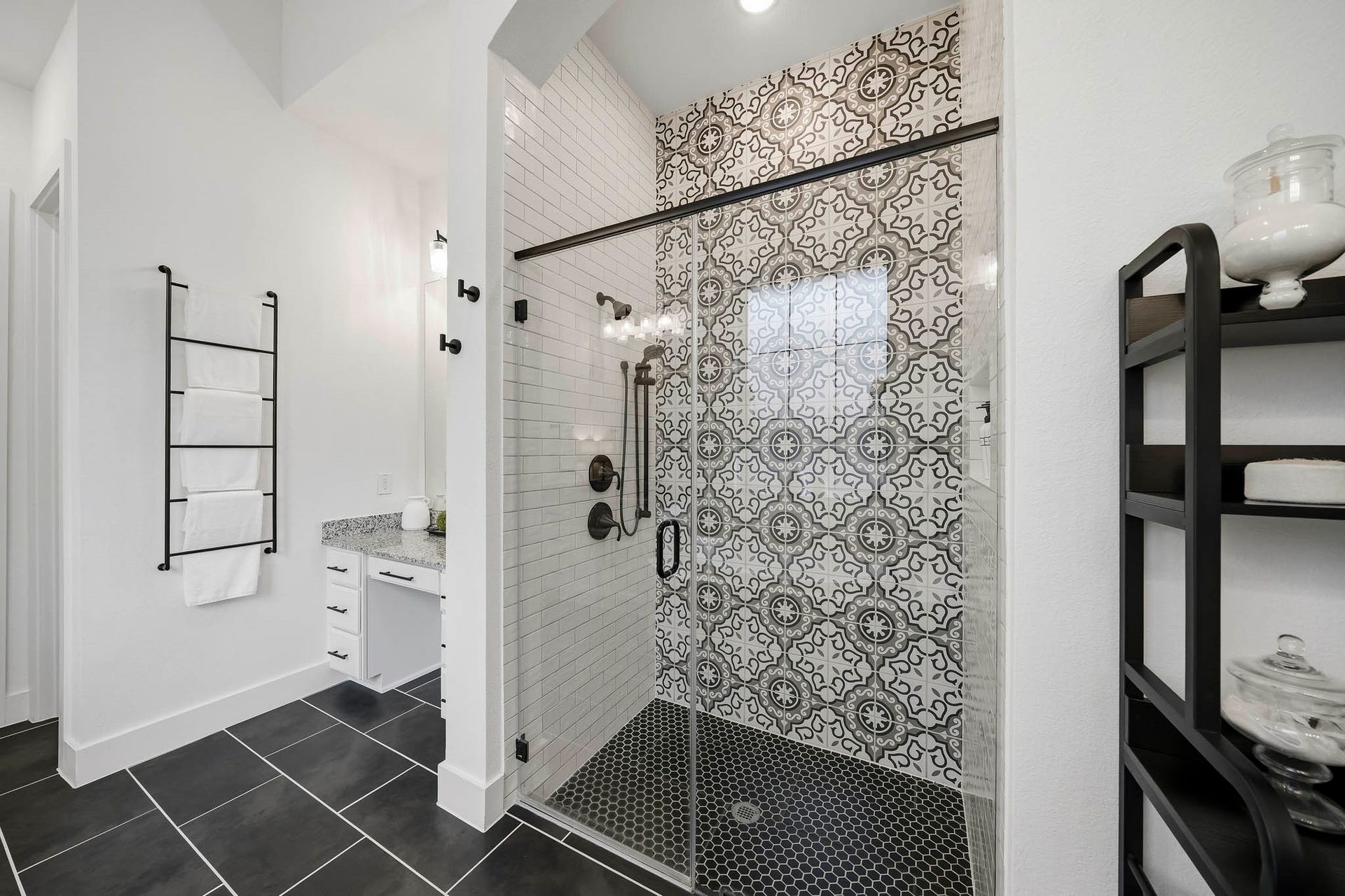 2514 Heritage Park Drive, Missouri City, TX 77459 The impressive walk-in shower is finished with hexagonal tile flooring, floor-to-ceiling subway and decorative tile, recessed lighting and a shower head with separate spray wand. A built-in soap and shampoo niche adds a clean, custom-finished touch.