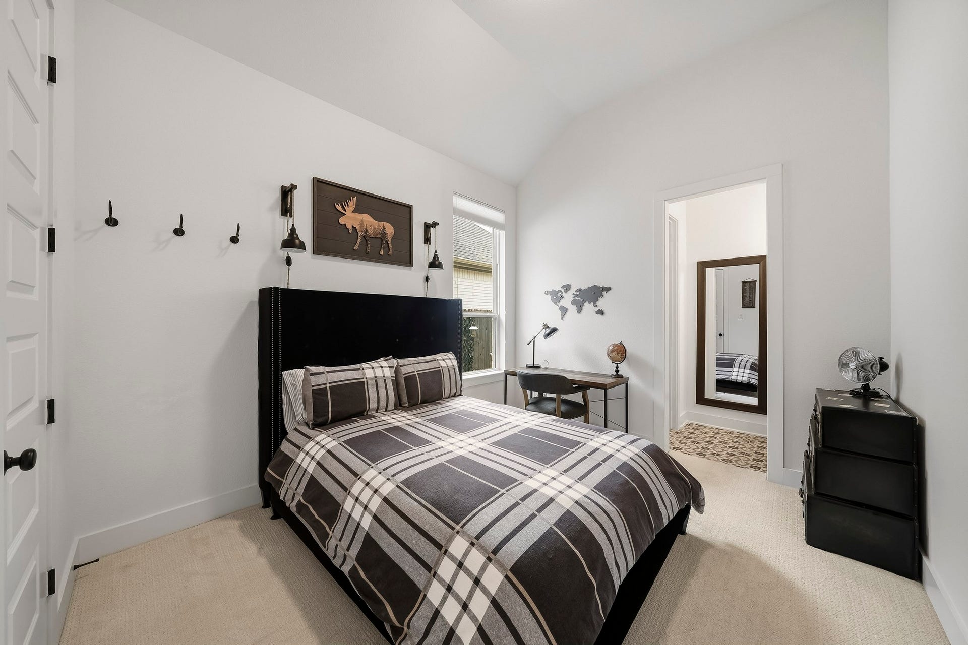2514 Heritage Park Drive, Missouri City, TX 77459 The third bedroom is enhanced by tall ceilings, a decorative light fixture and a window with shades that fills the space with natural light while maintaining comfort and privacy.