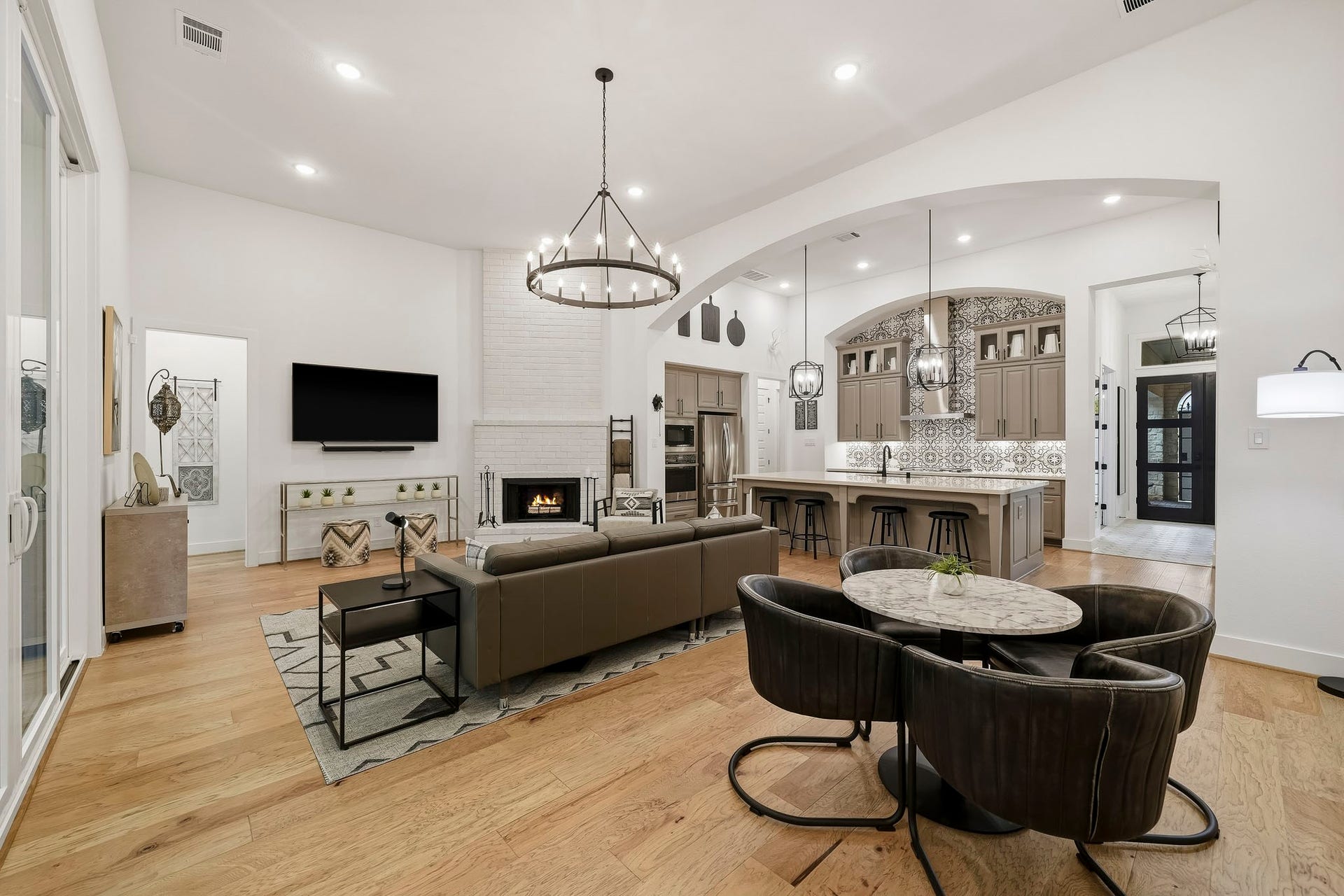 2514 Heritage Park Drive, Missouri City, TX 77459 Designed with the feel of a custom home, the dining area, living room and kitchen unfold in a beautifully integrated layout, creating an impressive sense of openness while allowing each space to retain its own distinct character. The decorative archway leading to the kitchen and floor to ceiling bricked fireplace add architectural style to the space.