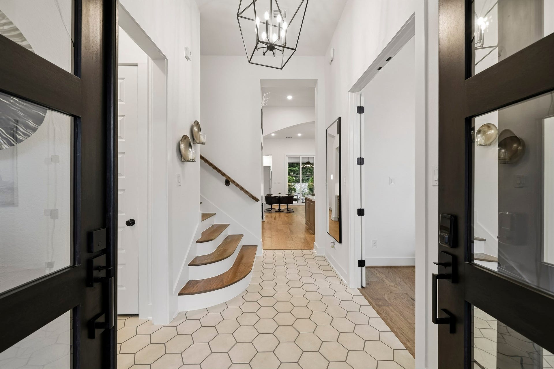 2514 Heritage Park Drive, Missouri City, TX 77459 Greeted with a memorable first impression through elegant 8-foot glass double entry doors, the home opens to a dramatic foyer showcasing striking hexagonal tile flooring and a statement chandelier that adds a sophisticated touch. This exceptional home has too many upgrades to mention. You'll find designer touches throughout every room.