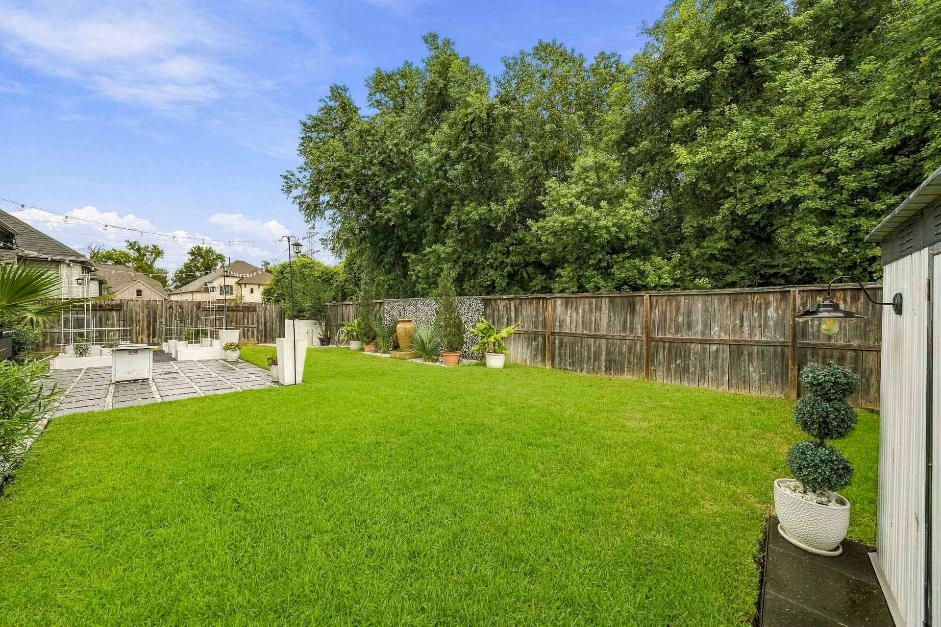 2514 Heritage Park Drive, Missouri City, TX 77459 The private back yard features a stone paver patio with built-in garden boxes and a storage shed that remains with the home, all enhanced by the peaceful nature preserve beyond for exceptional privacy and a serene natural backdrop.
