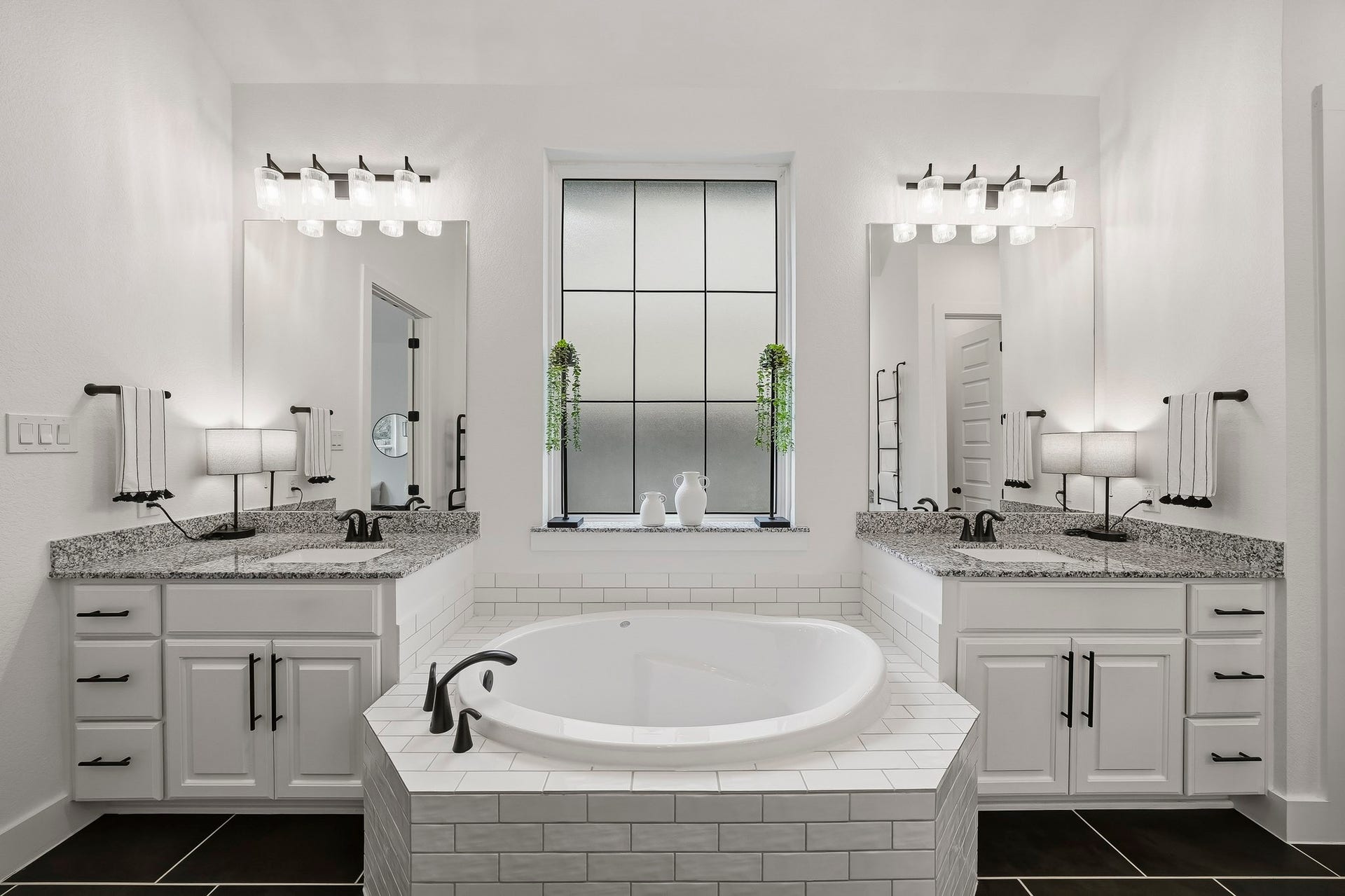 2514 Heritage Park Drive, Missouri City, TX 77459 Another view of the soaking tub flanked by dual sinks, separate dressing areas and full mirrors topped by decorative light fixtures.