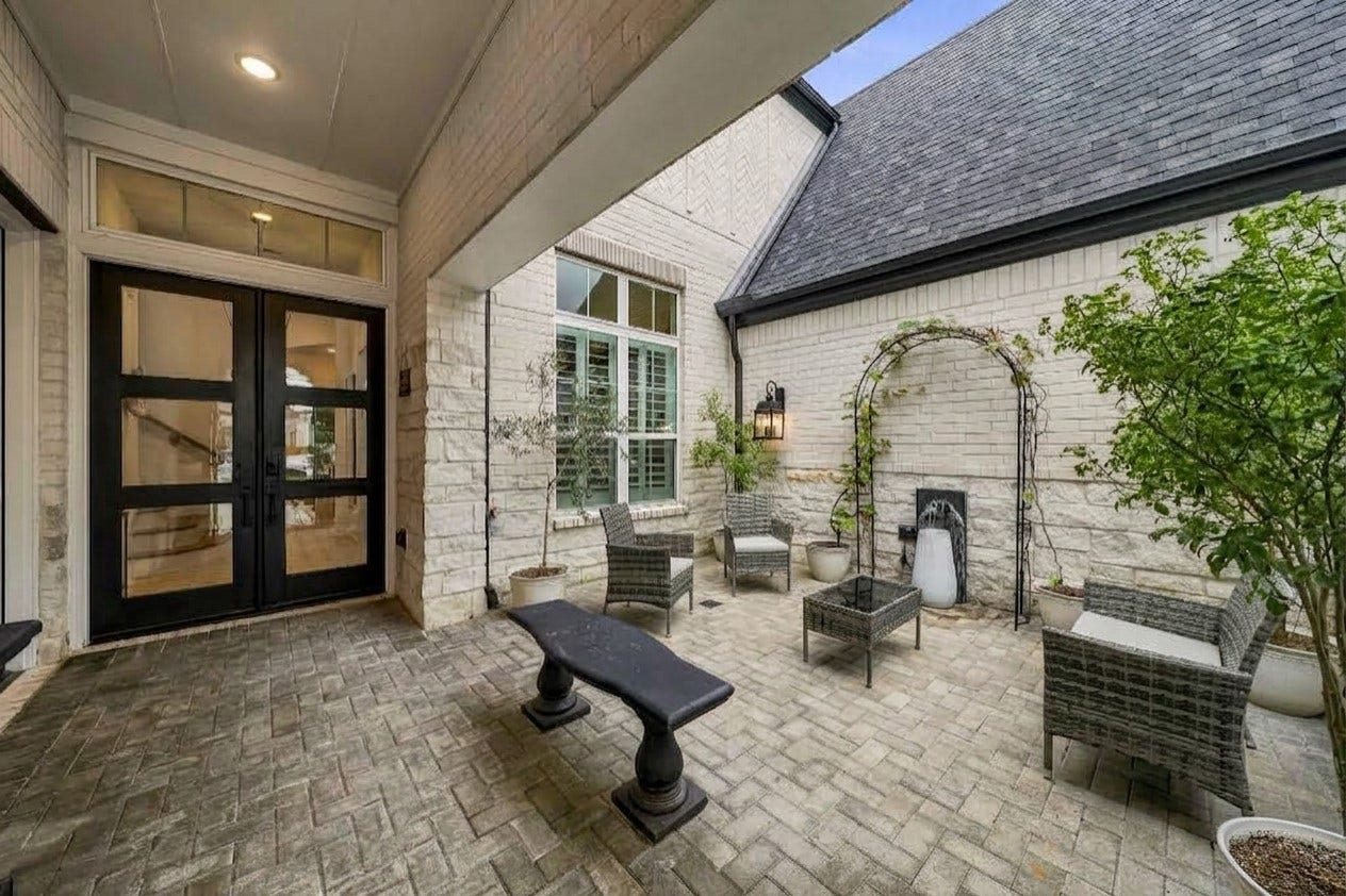 2514 Heritage Park Drive, Missouri City, TX 77459 This exceptional Highland Home makes a striking first impression with its richly detailed brick-and-stone exterior, distinctive architectural design and elevated curb appeal that reflects quality craftsmanship throughout. A custom gated rare private courtyard greets you upon entry to this stunning 1.5 story home.