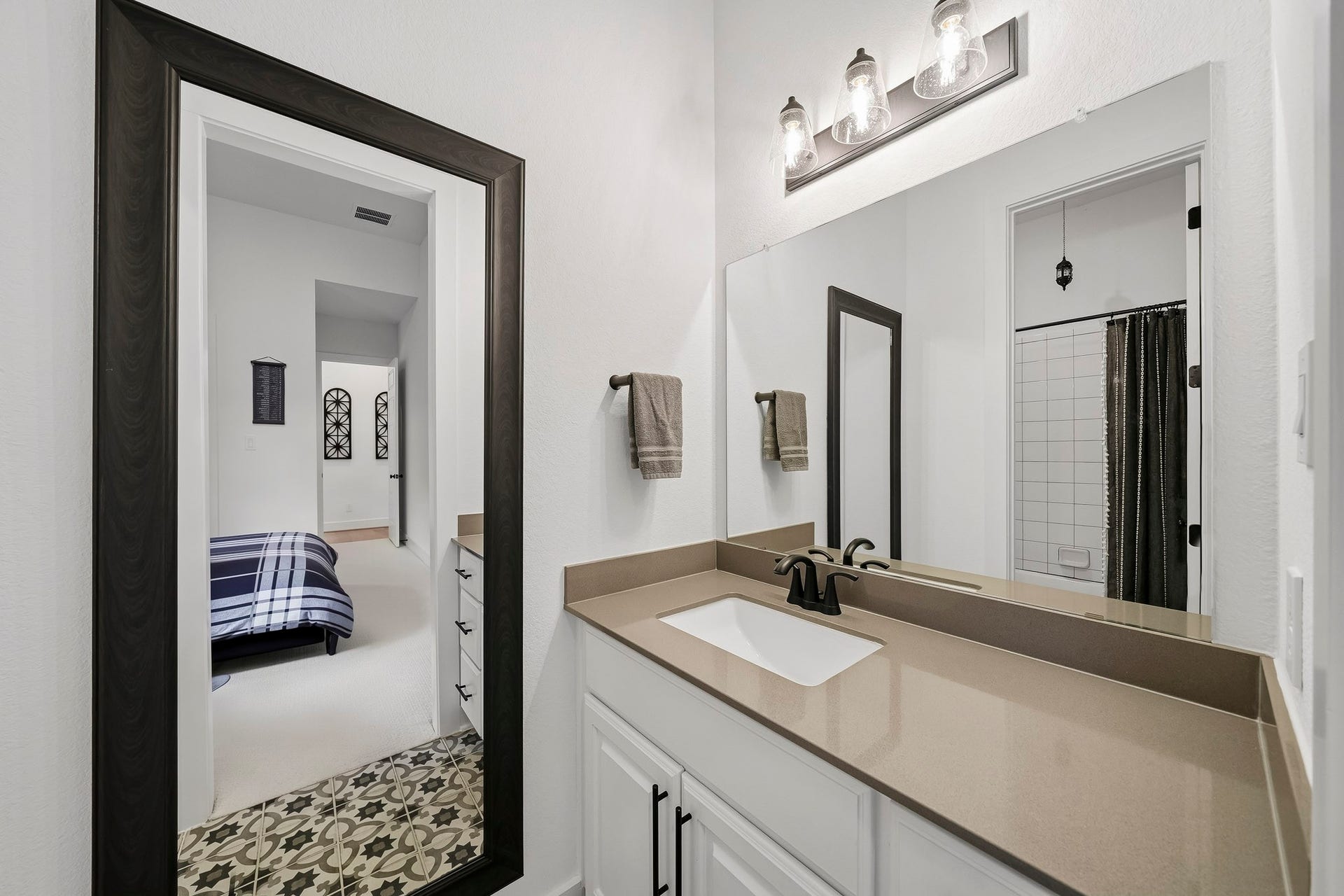 2514 Heritage Park Drive, Missouri City, TX 77459 The third bath features a Hollywood-style dressing area with a sink, Quartz counter with a mirror and light fixture above.