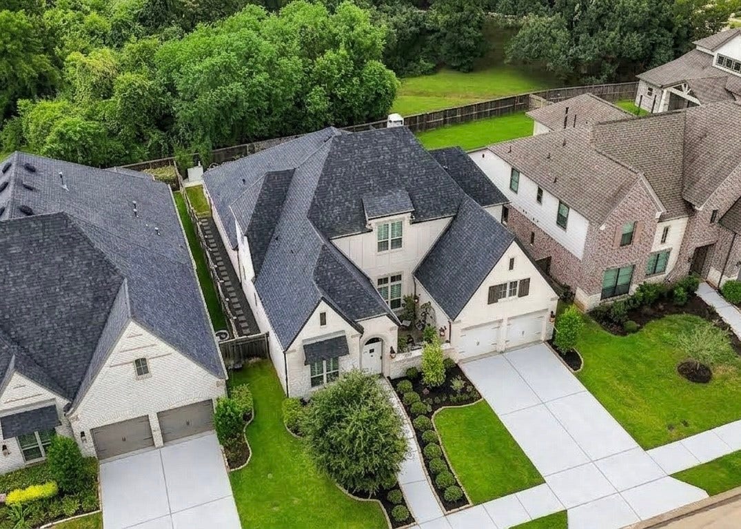 2514 Heritage Park Drive, Missouri City, TX 77459 With gated access to the backyard, a paved walkway leads you to the beautiful backyard. This aerial view shows the expansive nature reserve with no neighbors behind creating a private setting for everyday living. Blending the quality craftsmanship of a Highland Home with distinctive thoughtful style and the welcoming atmosphere of Heritage Park, this exceptional residence is ready to be enjoyed for years to come. Welcome to Sienna!