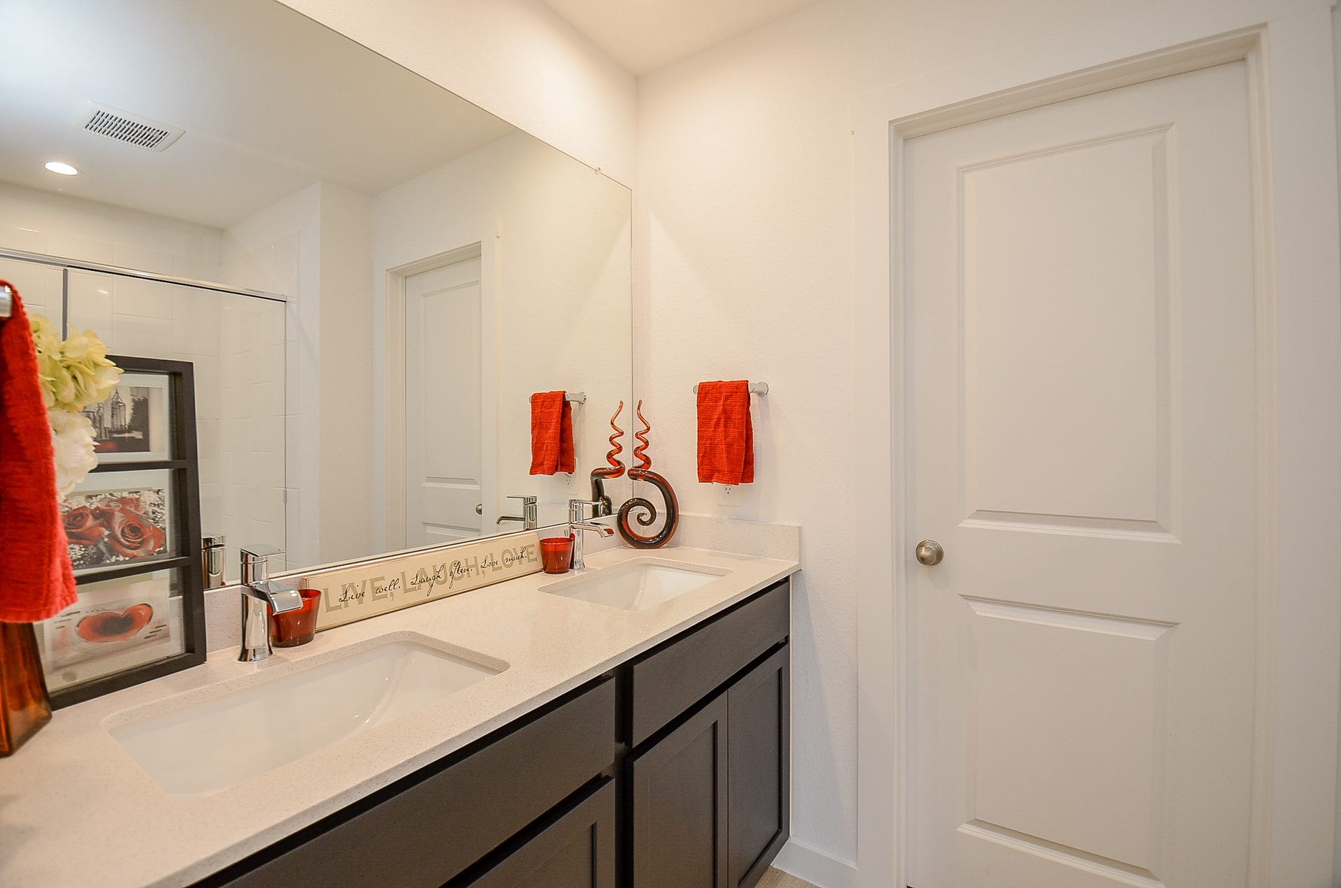 7814 Bel Fiore Drive, Richmond, TX 77406 Modern bathroom featuring a sleek double vanity with a large mirror.