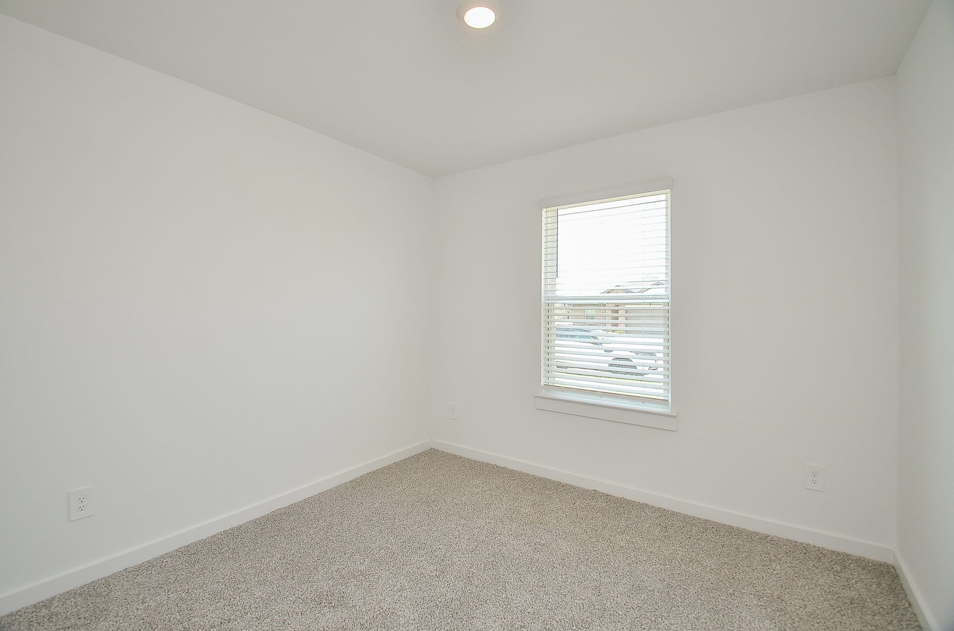 7814 Bel Fiore Drive, Richmond, TX 77406 Bright and cozy room with soft carpeting, neutral walls, and ample natural light from a large window.