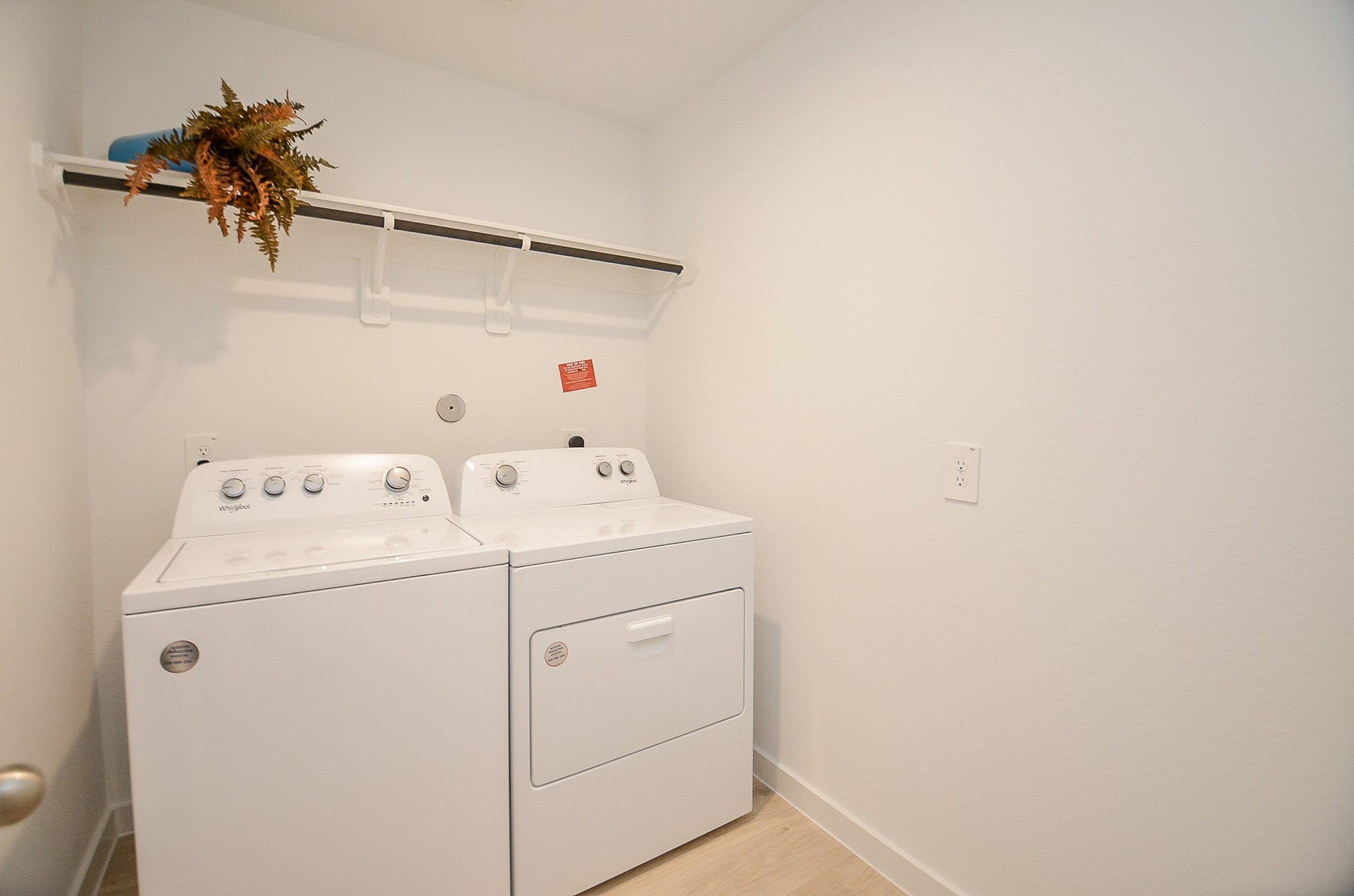7814 Bel Fiore Drive, Richmond, TX 77406 Bright and functional laundry room featuring modern washer and dryer, with a convenient overhead shelf for storage.