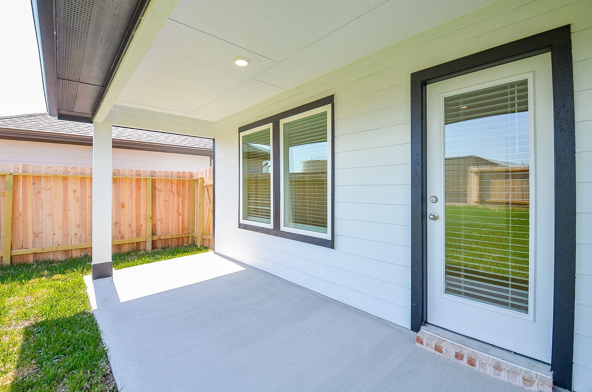 7814 Bel Fiore Drive, Richmond, TX 77406 Charming covered patio with clean lines and ample natural light, perfect for relaxing and enjoying the private fenced yard.
