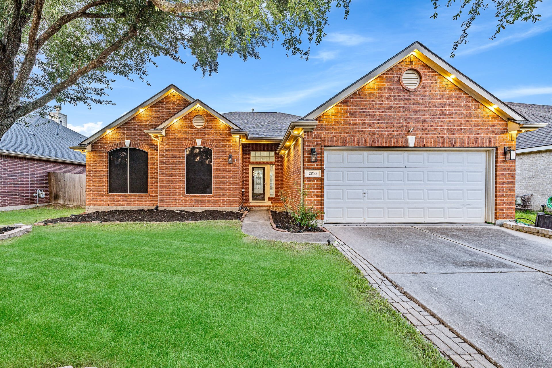 Beautiful brick exterior with mature shade tree and great curb appeal.