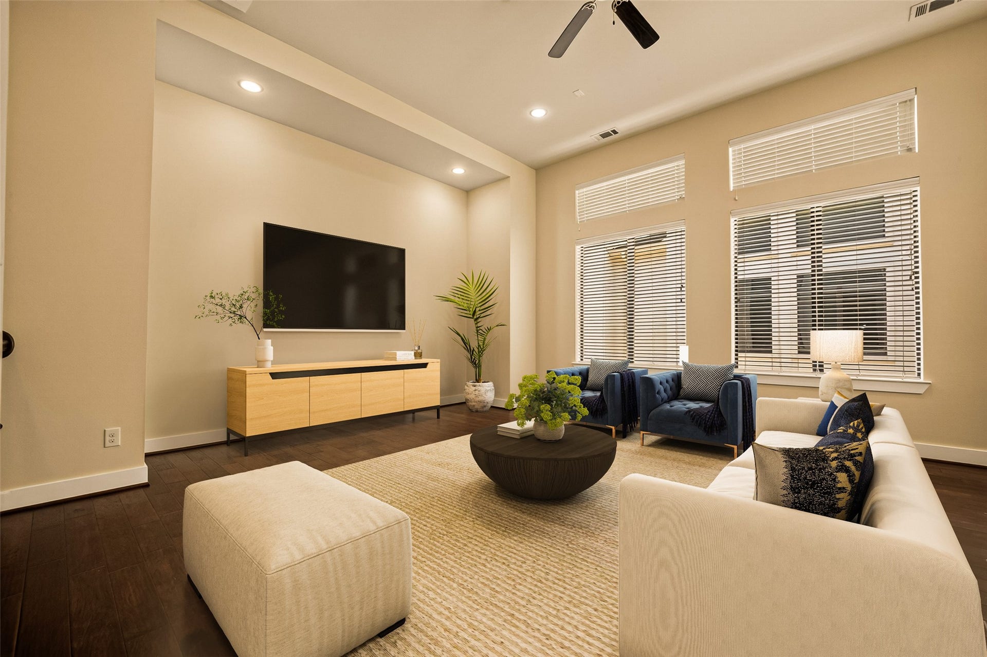 40 N Hutcheson Street, Houston, TX 77003 Virtually Staged. Spacious living room with large windows for natural light and sleek hardwood floors creating a warm, inviting atmosphere.
