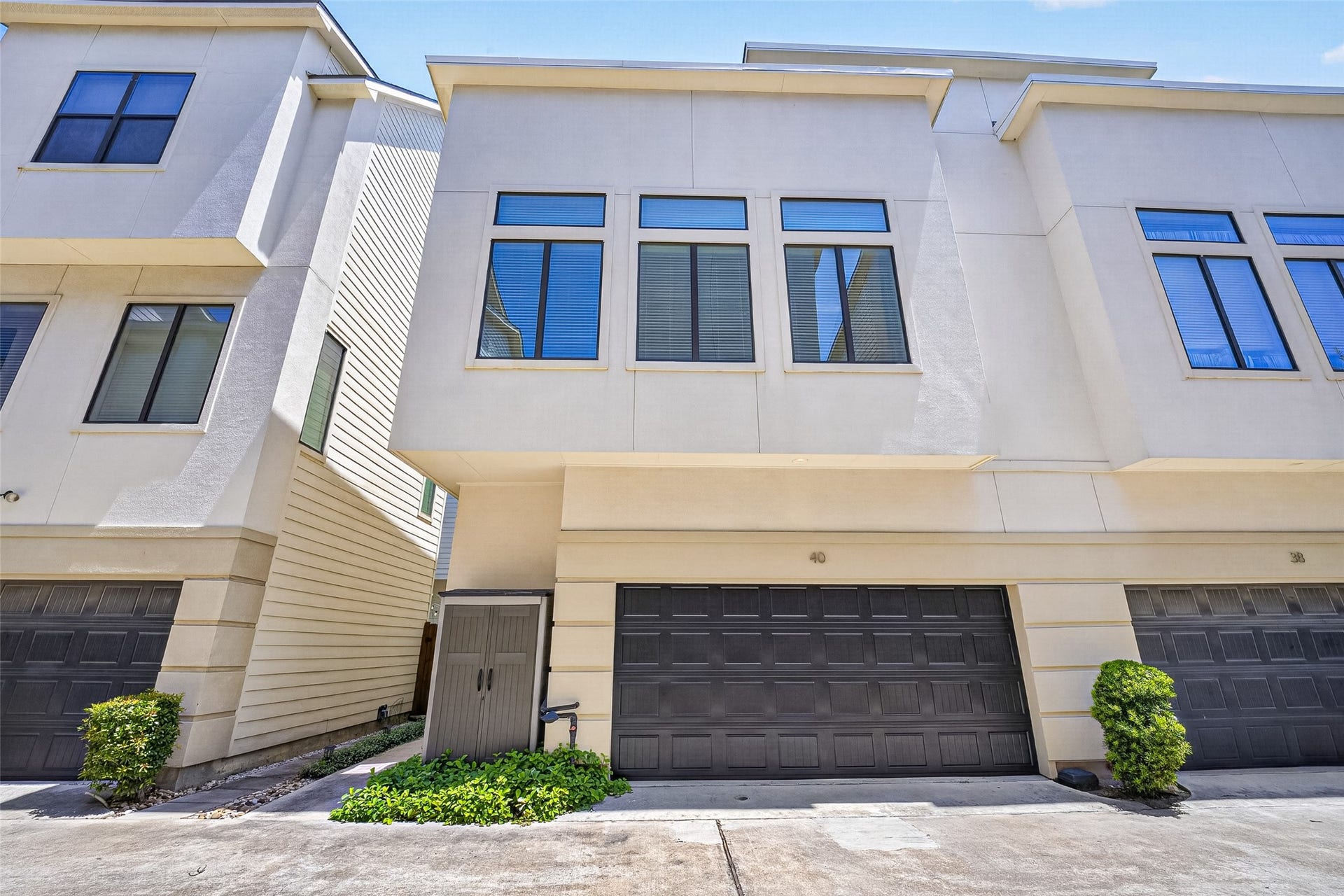 40 N Hutcheson Street, Houston, TX 77003 Modern townhouse featuring a sleek facade with large windows and an attached two-car garage, offering ample natural light and convenient parking.