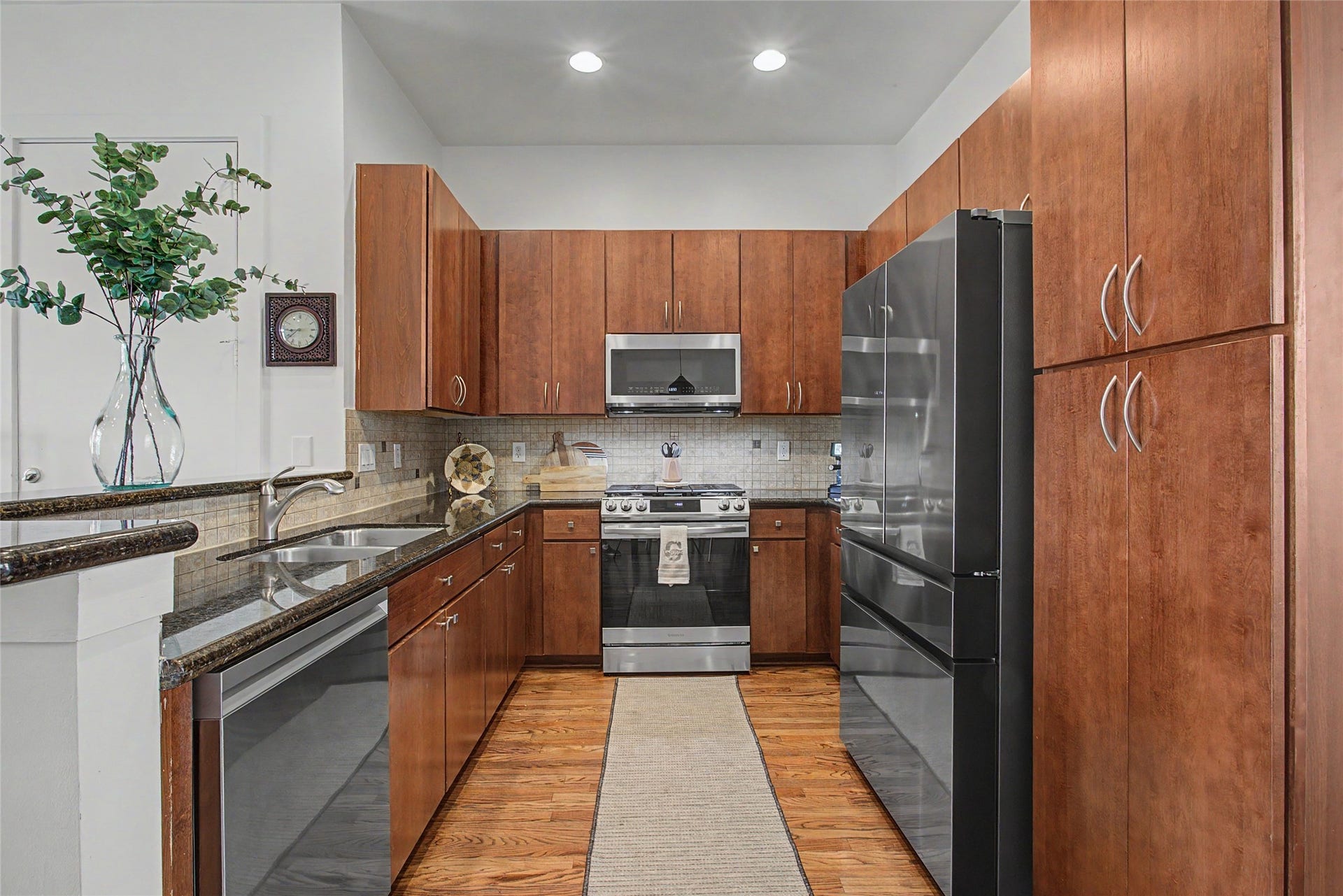 125 E 2nd Street, Houston, TX 77007 Kitchen features granite counters, breakfast bar and 2 year old Samsung stainless steel appliances.