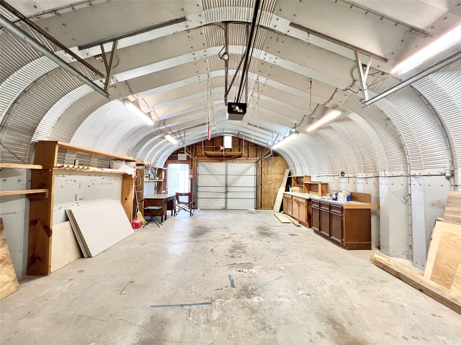 3806 Peck Street, Santa Fe, TX 77517 Electric with plenty of lights, additional cabinets and workspace stay. Auto Garage Door Opener and an additional garage door on the other end to pull through and for cross ventilation.