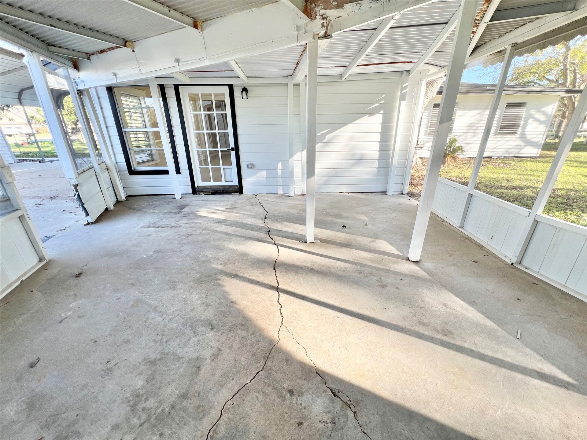 3806 Peck Street, Santa Fe, TX 77517 Under the screened in back patio that attaches the oversized garage and workshop to the home.
