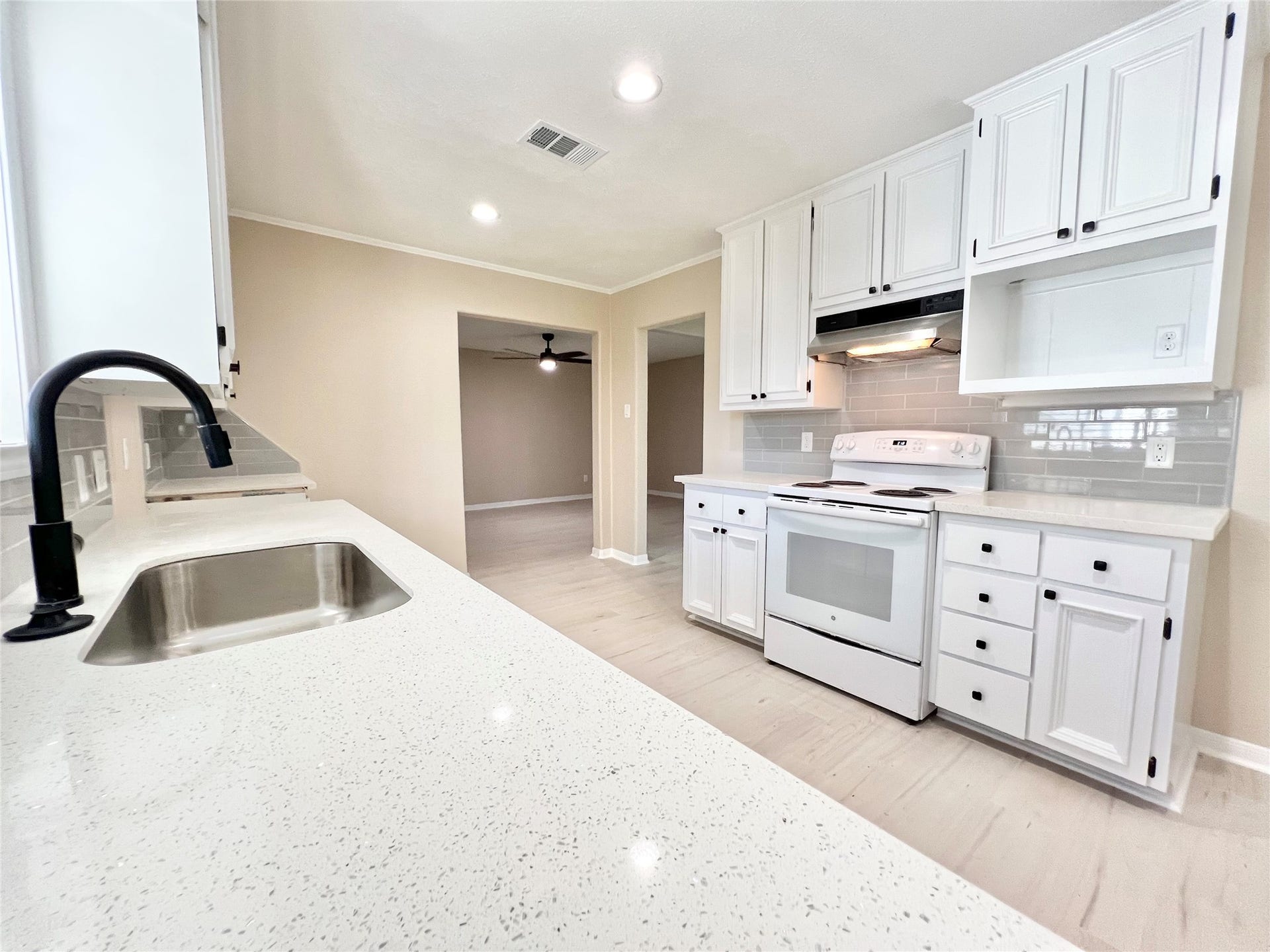 3806 Peck Street, Santa Fe, TX 77517 New faucet and sink, with disposal, freshly painted solid wood cabinets and LED lighting.