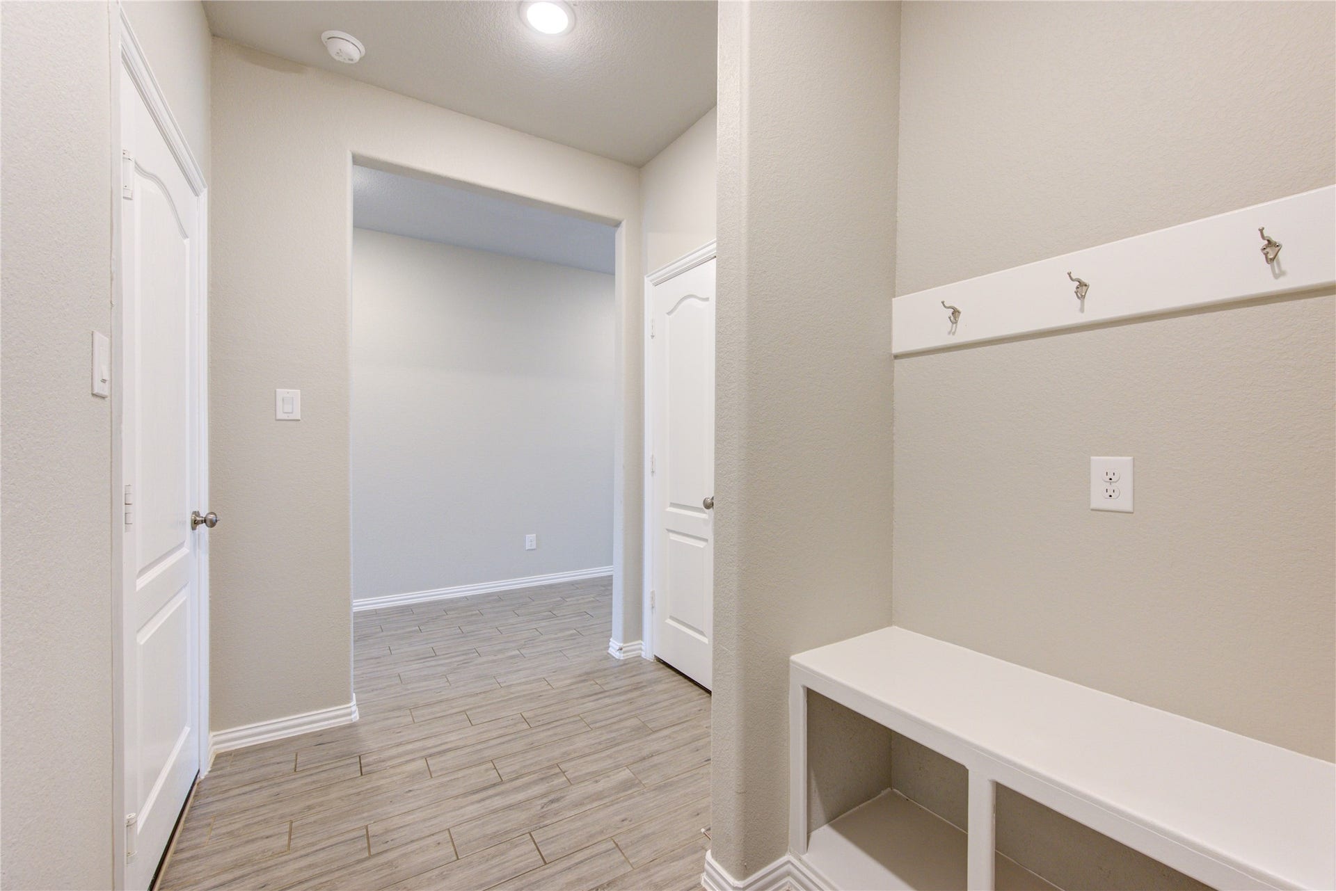 Built-in entry bench with storage and hooks for added convenience and organization