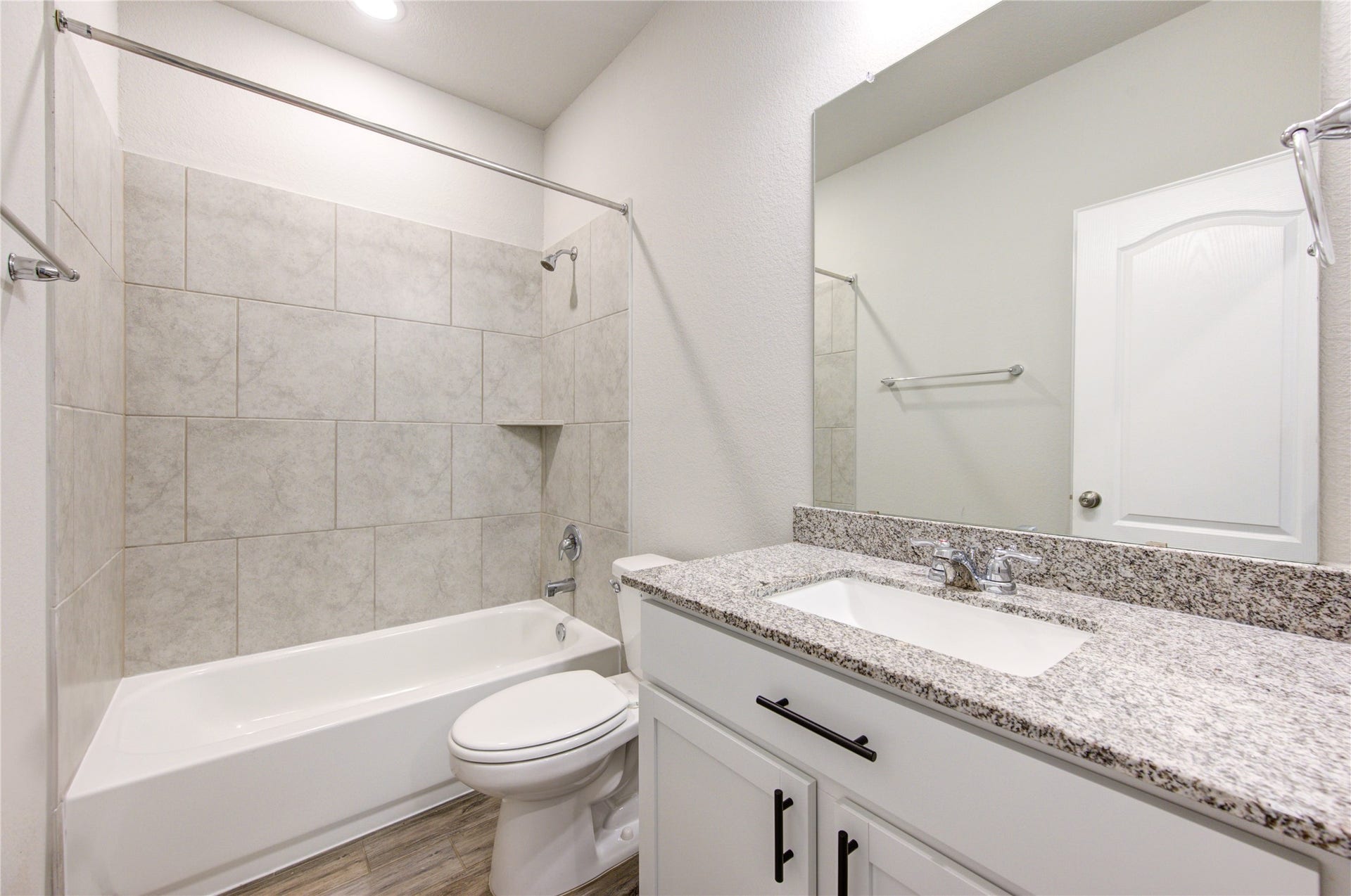 full secondary bathroom with tub/shower combination and ample vanity space
