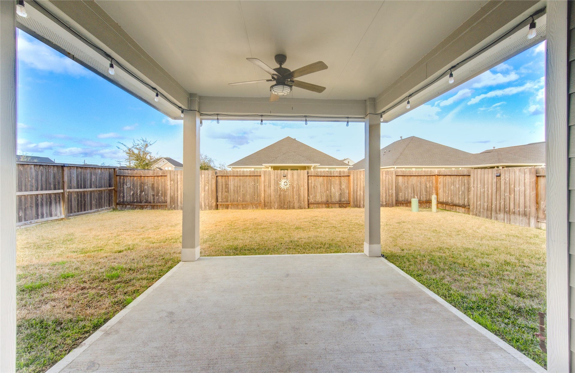Large covered back patio with ceiling fans