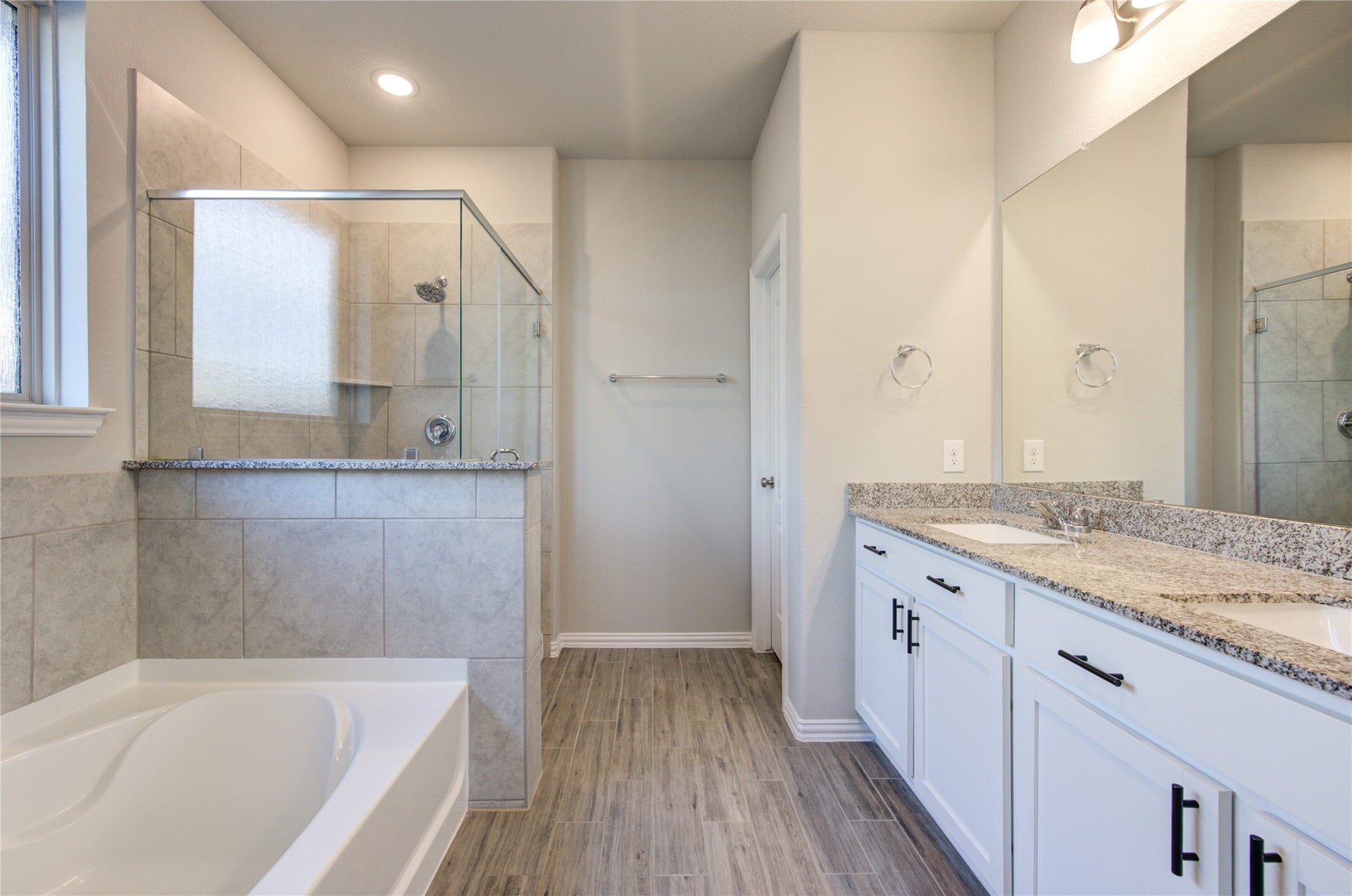 Primary bathroom with dual sinks, soaking tub and walk-in shower